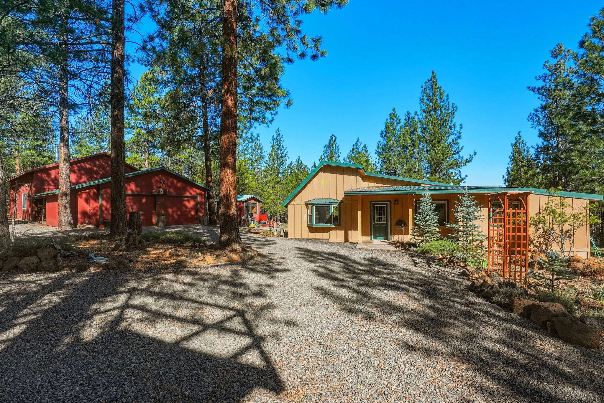 2 of 61. Nestled among towering trees, this unique property features a remodeled pre-1940 hunting cabin, a detached oversized 2-car garage, a 30'x40' shop with an RV bay, 2 insulated rooms, storage areas, and spacious outdoor areas for relaxation.