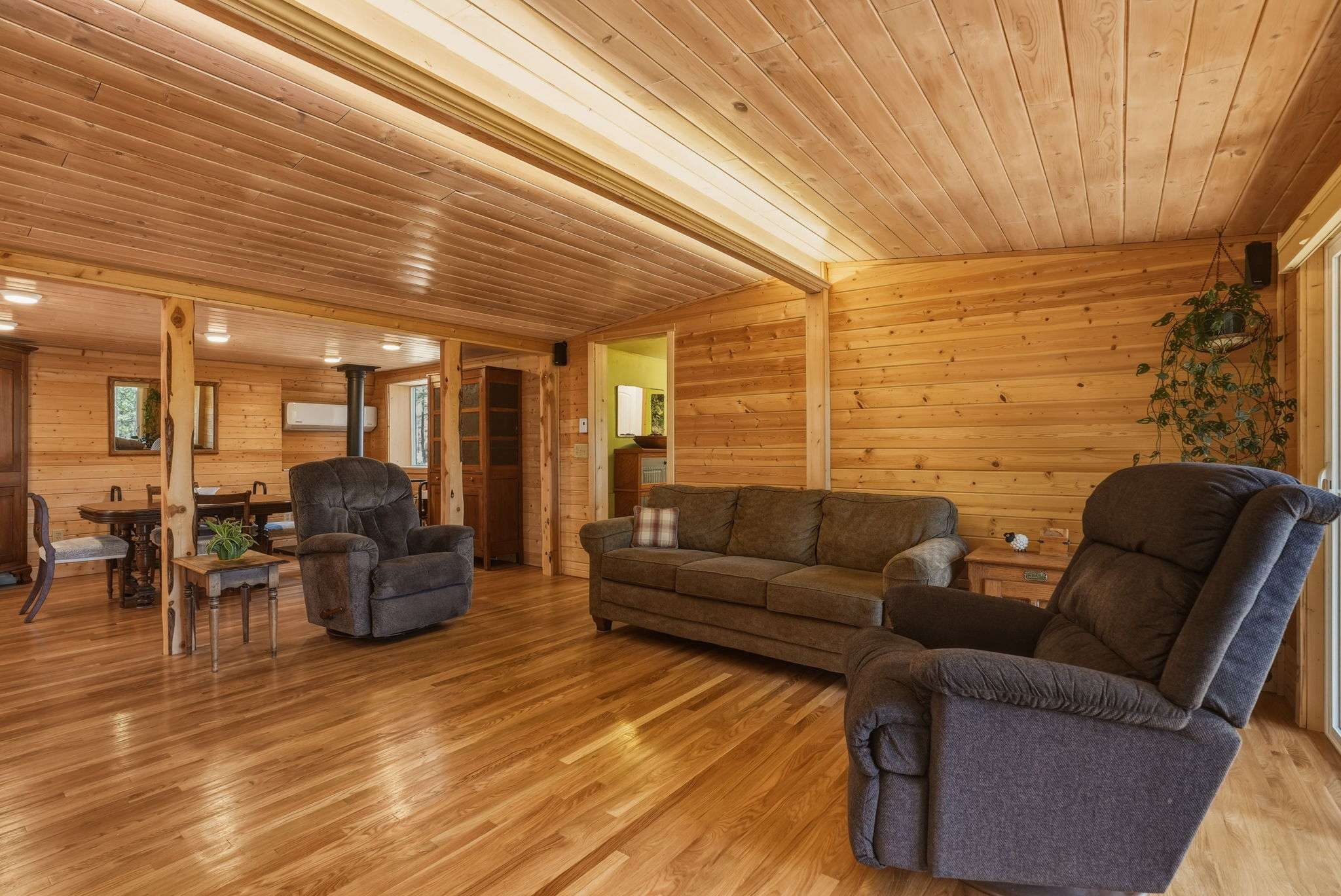 14 of 61. Spacious, warm living area features natural wood accents and comfortable seating for relaxed gatherings.