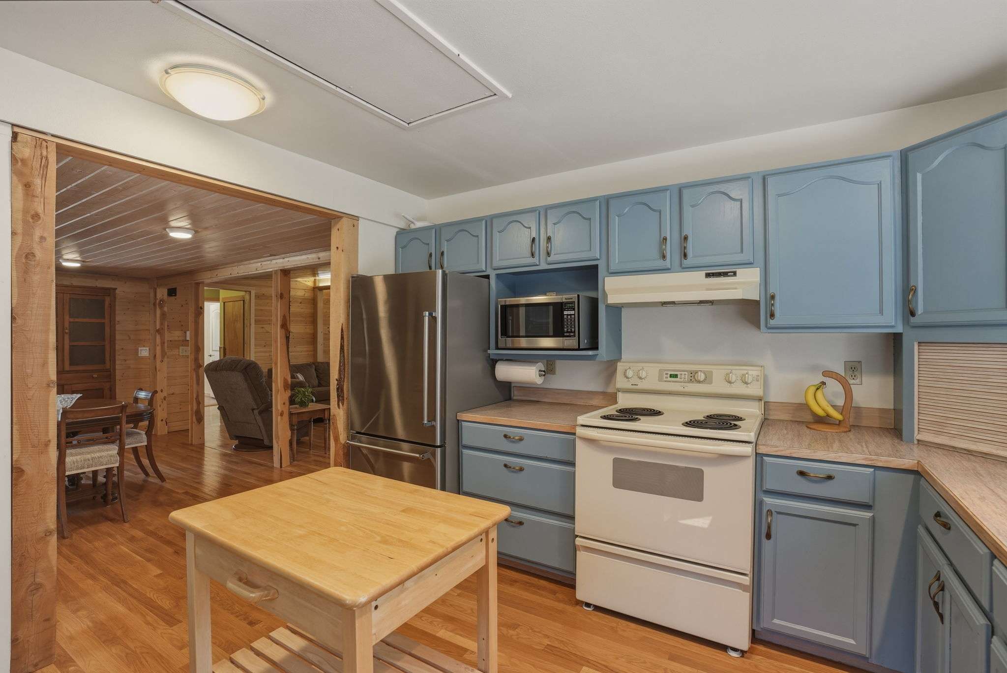19 of 61. Bright and functional kitchen featuring modern appliances, laminate countertops, and seamless flow into the dining area.