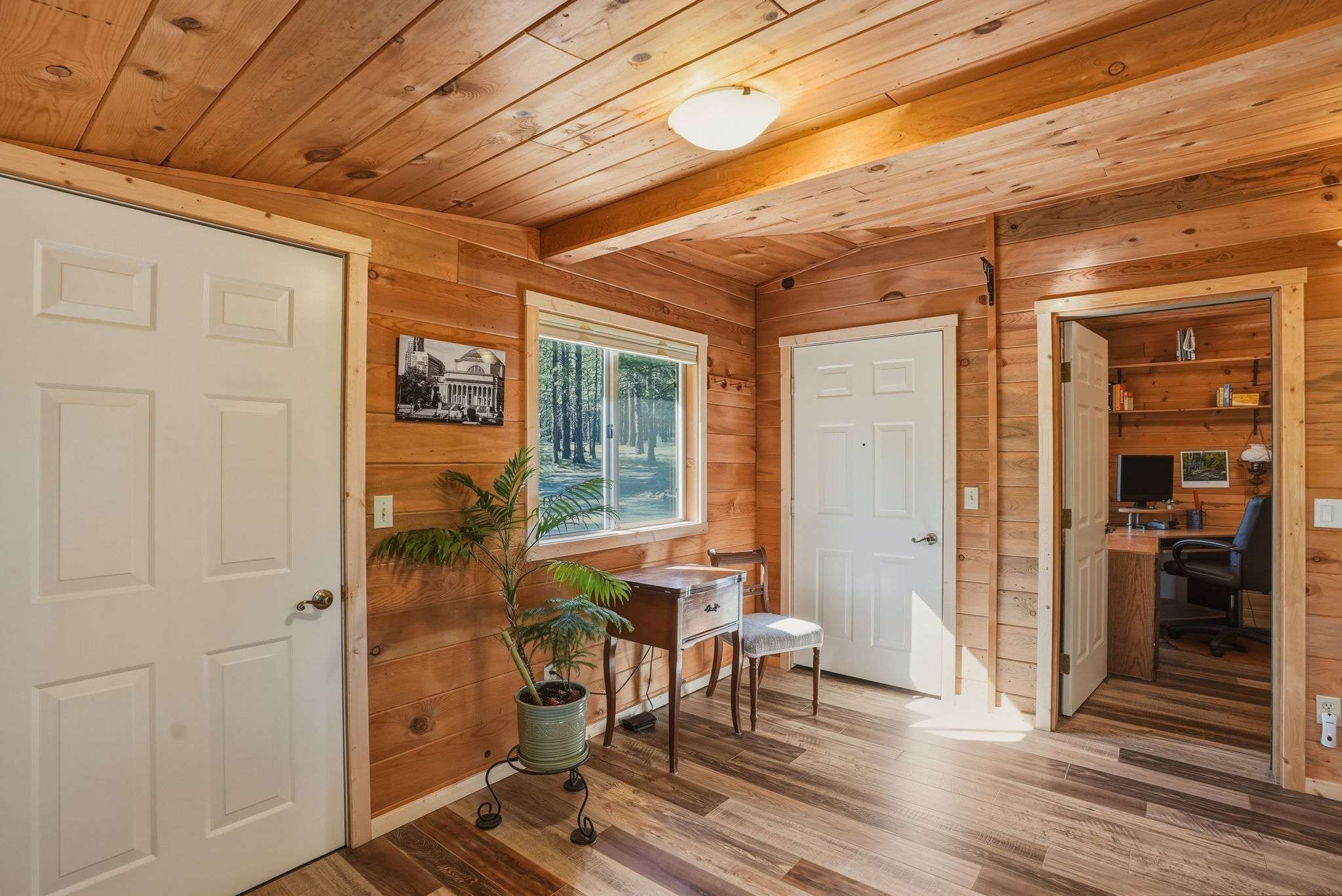 25 of 61. Cozy wooden interior with abundant natural light, perfect for a home office or quiet retreat.