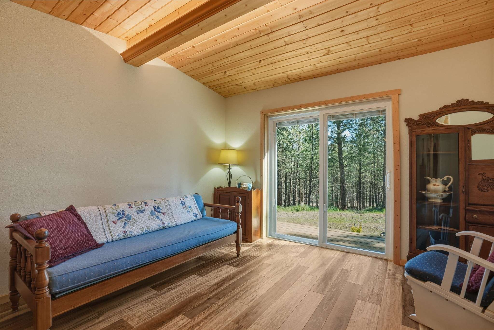 27 of 61. Bright living space with wooden beams and direct access to a private outdoor view.