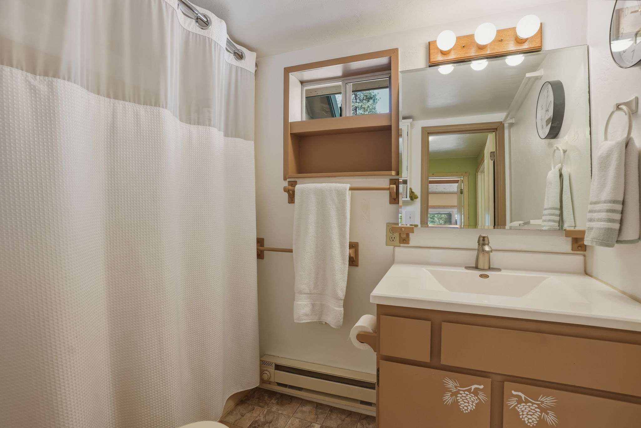 29 of 61. Bright bathroom featuring a functional layout with ample storage and a crisp, clean ambiance.