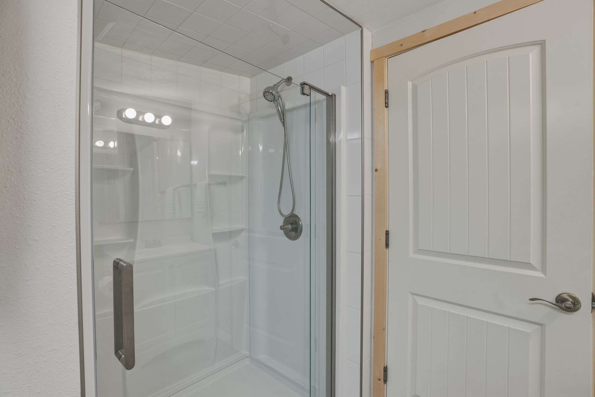 37 of 61. Modern glass shower with sleek fixtures, offering a fresh and functional space for daily routines.