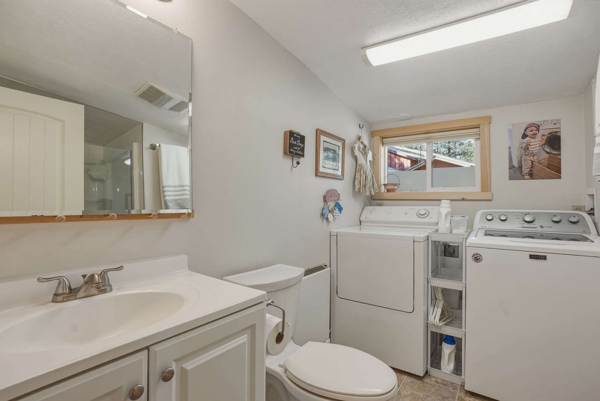 38 of 61. This functional laundry room features convenient appliances and ample natural light from a large window.