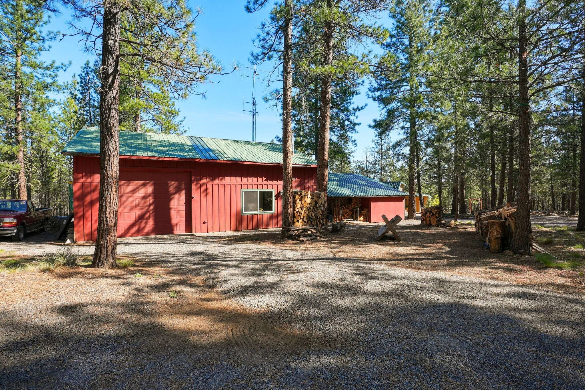 41 of 61. 30'x40' shop with a 30'x16.5' RV bay and two additional 22'x14' rooms. The 2-car oversized garage has an insulated storage area with baseboard heat. Outside is a 12'x6' shed and a 16'x6' covered wood storage area. The detached pump house/greenhouse is 12'x8'.