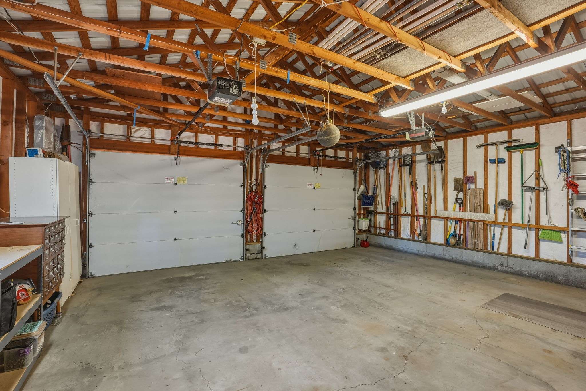 49 of 61. The 2-car oversized garage has heated storage, dedicated wood storage, and a storage room. Plus exterior shed and wood storage.