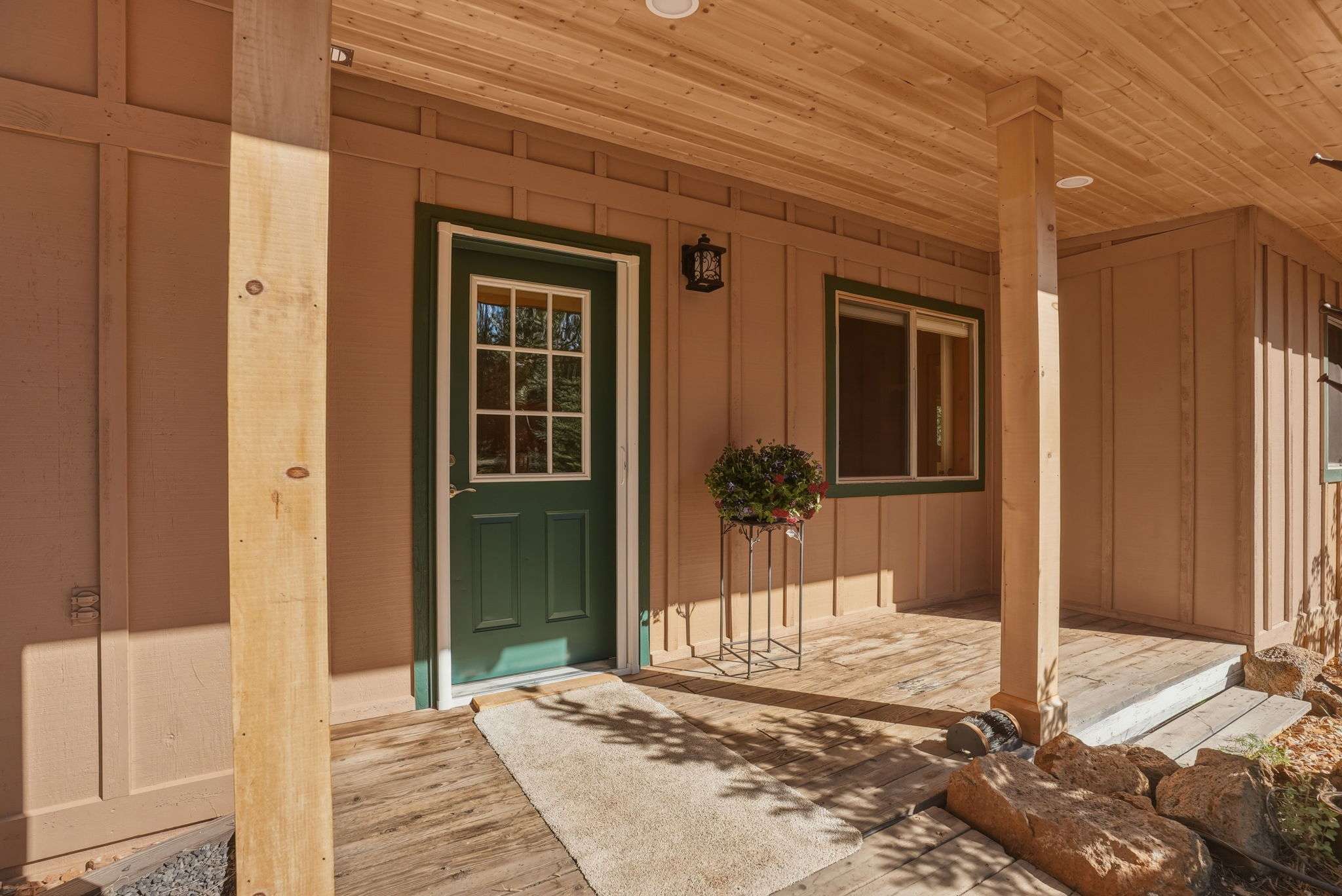 6 of 61. Welcoming entryway with a covered porch and well-maintained landscaping, perfect for relaxing outdoors.