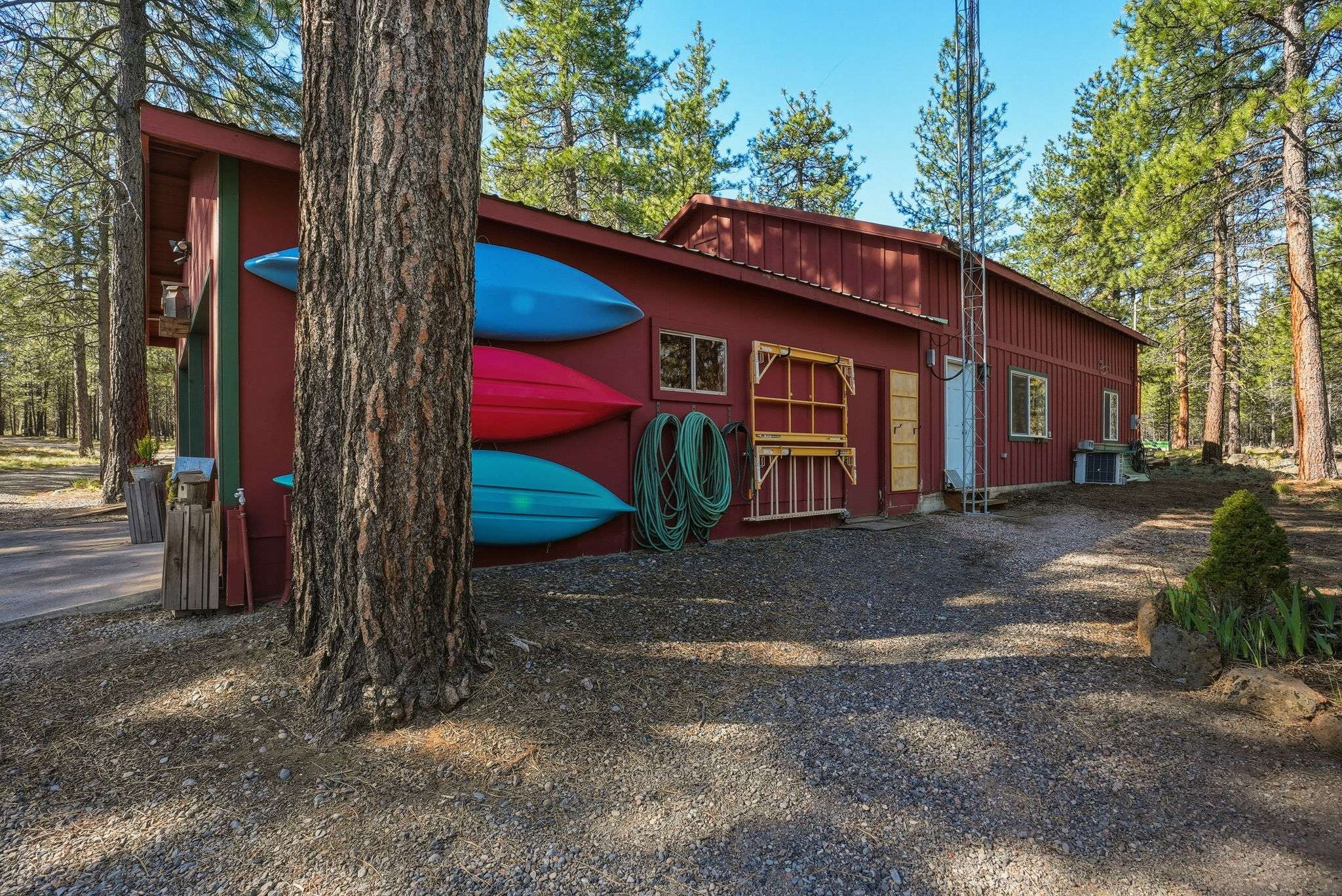40 of 61. 30'x40' shop with a 30'x16.5' RV bay and two additional 22'x14' rooms. The 2-car oversized garage has an insulated storage area with baseboard heat. Outside is a 12'x6' shed and a 16'x6' covered wood storage area. The detached pump house/greenhouse is 12'x8'.