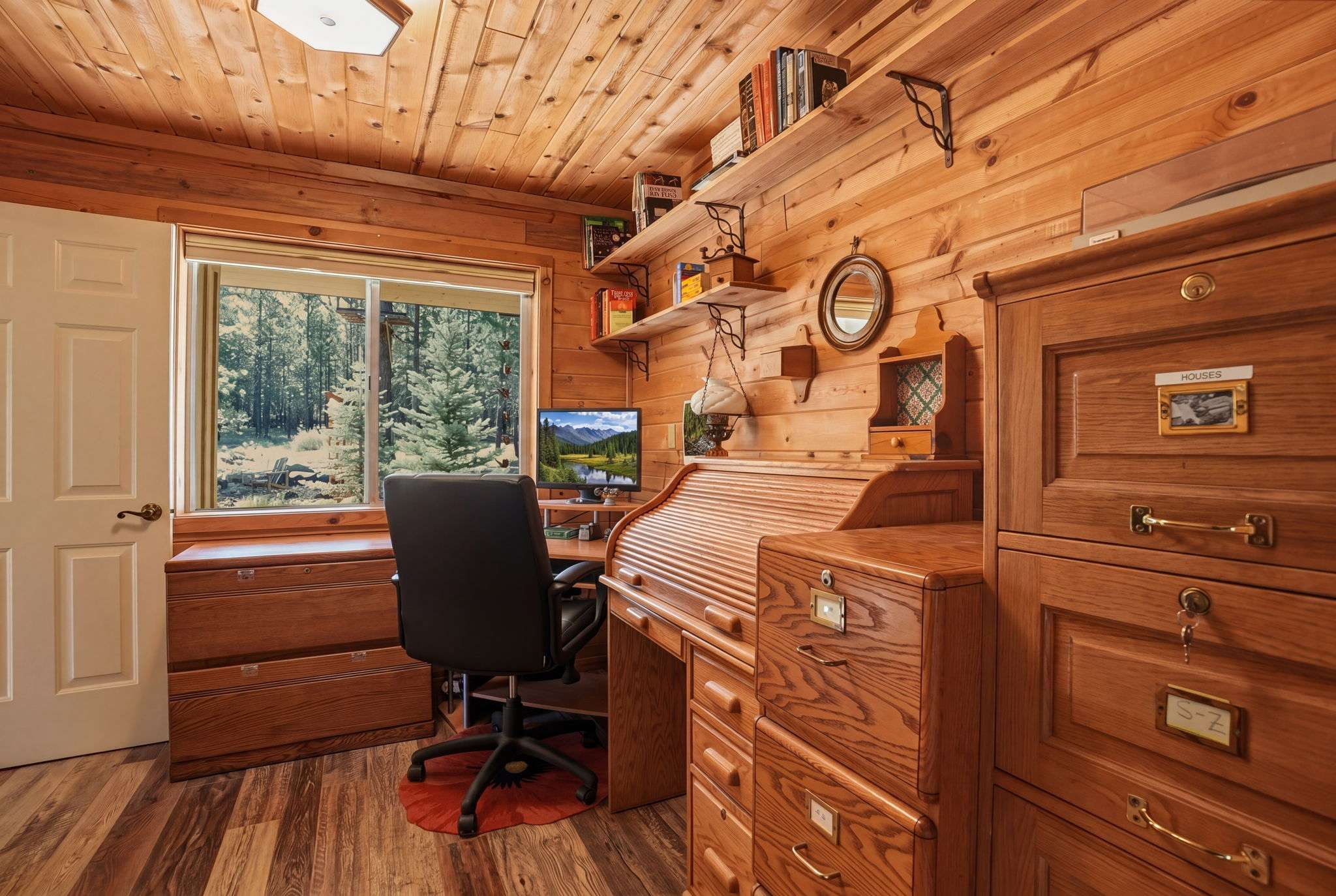 24 of 61. Cozy office space featuring natural wood accents, ample storage, and picturesque views of surrounding nature.