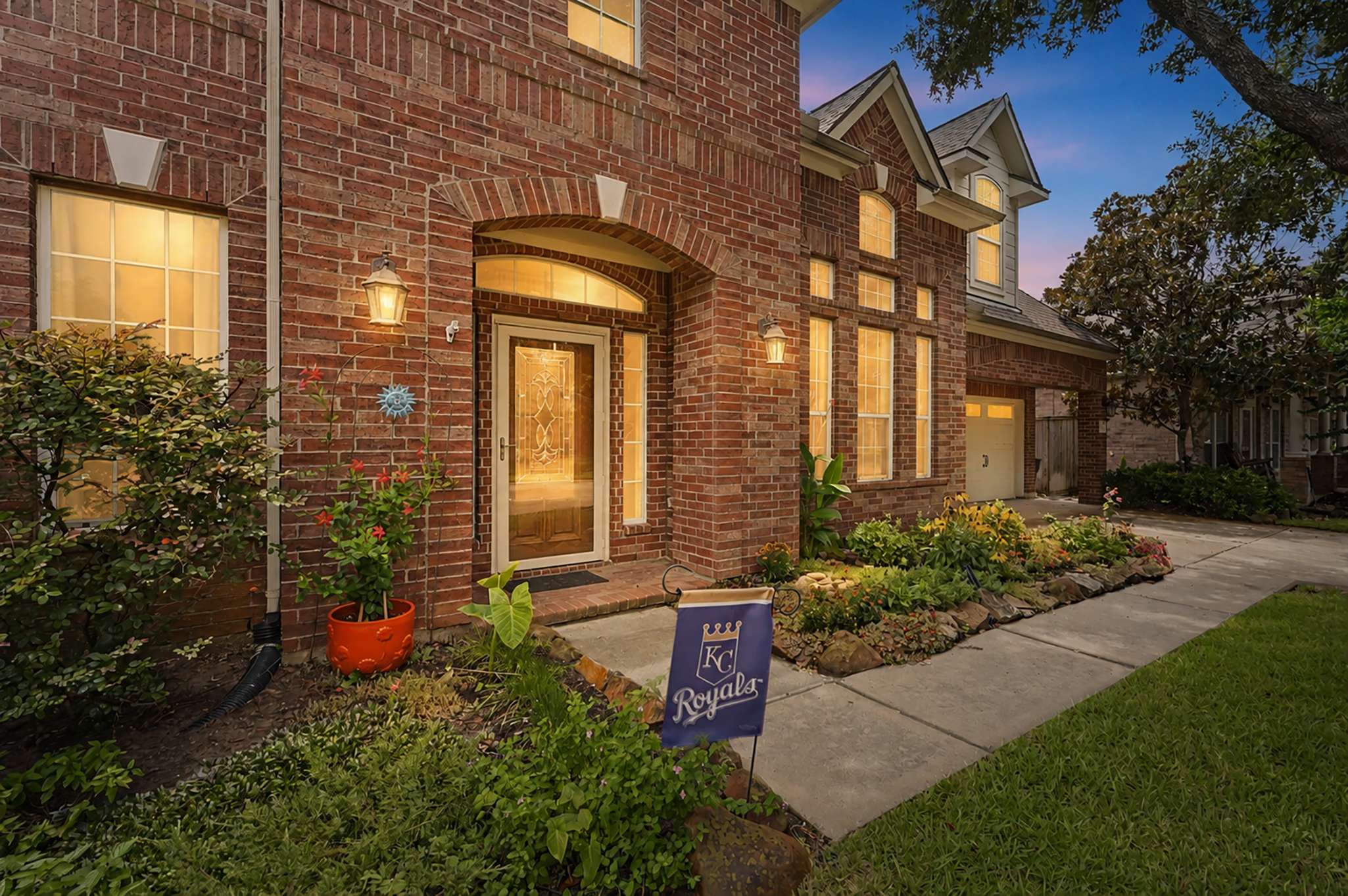 11 of 71. Stunning brick façade home featuring vibrant landscaping and abundant natural light, perfect for modern living.