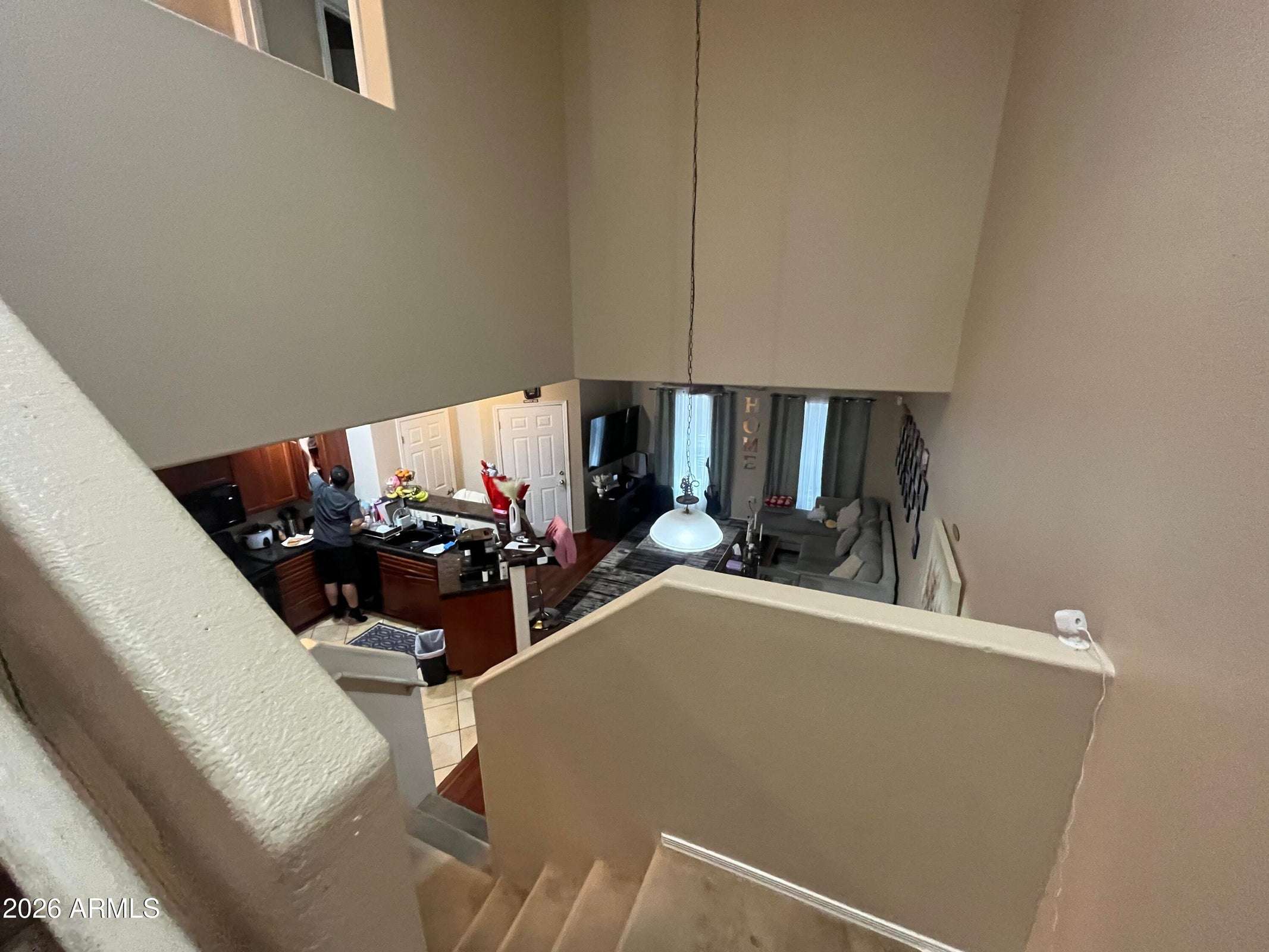 5 of 26. The open-concept design seamlessly connects the kitchen, dining, and living spaces beneath soaring ceilings, creating a bright and welcoming atmosphere for entertaining.
