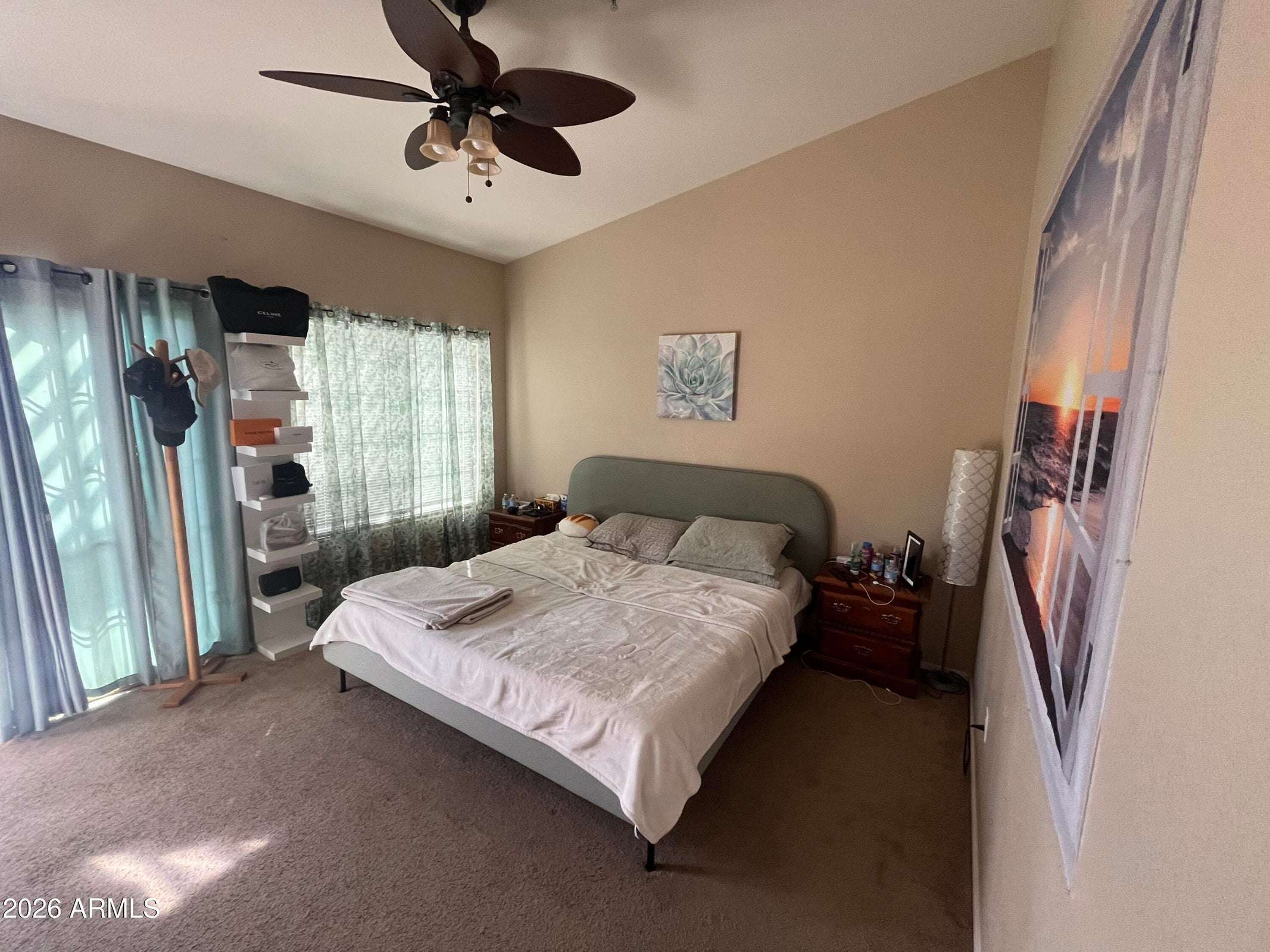 8 of 26. This spacious primary suite features vaulted ceilings, large windows, plush carpeting, and direct access to the private balcony for indoor-outdoor living.