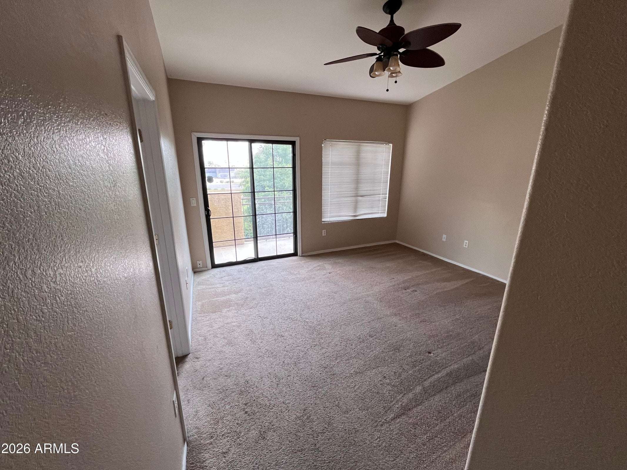 19 of 26. This bright primary suite includes sliding glass doors to the private balcony, vaulted ceilings, and generous floor space, creating an inviting owner's retreat.