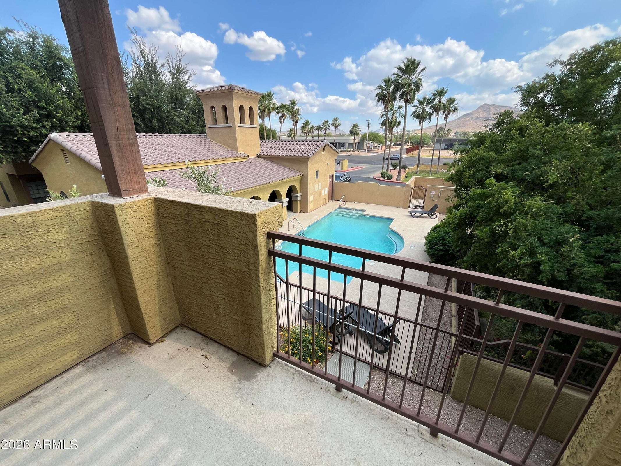 26 of 26. Step onto the private balcony to enjoy elevated views of the community pool, mature landscaping, and mountain backdrop. This peaceful outdoor space adds exceptional value to this Phoenix property.