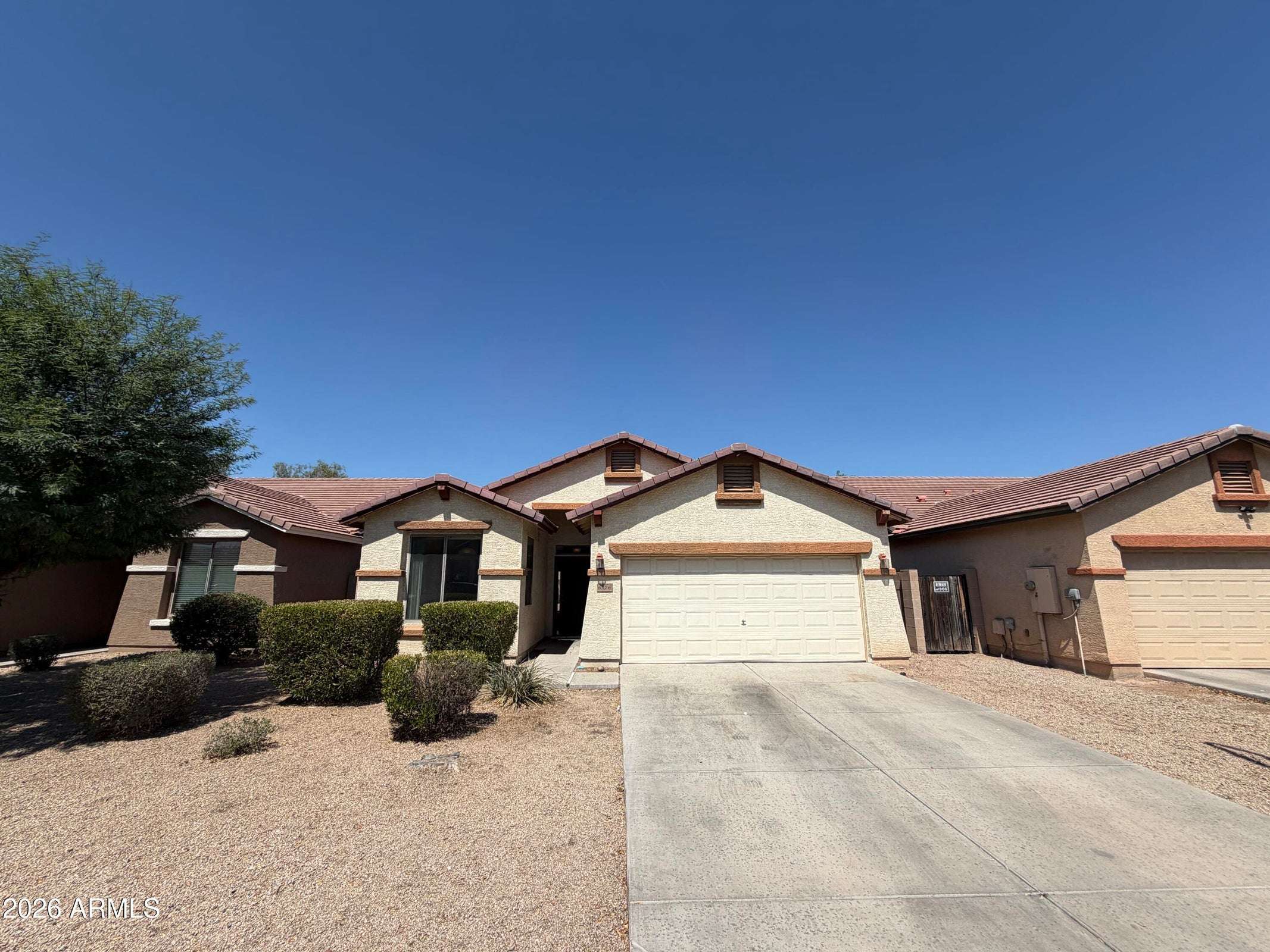 1 of 31. Well-maintained front exterior with attractive desert landscaping, attached two-car garage, and extended driveway. This Phoenix rental offers excellent curb appeal and easy outdoor maintenance.