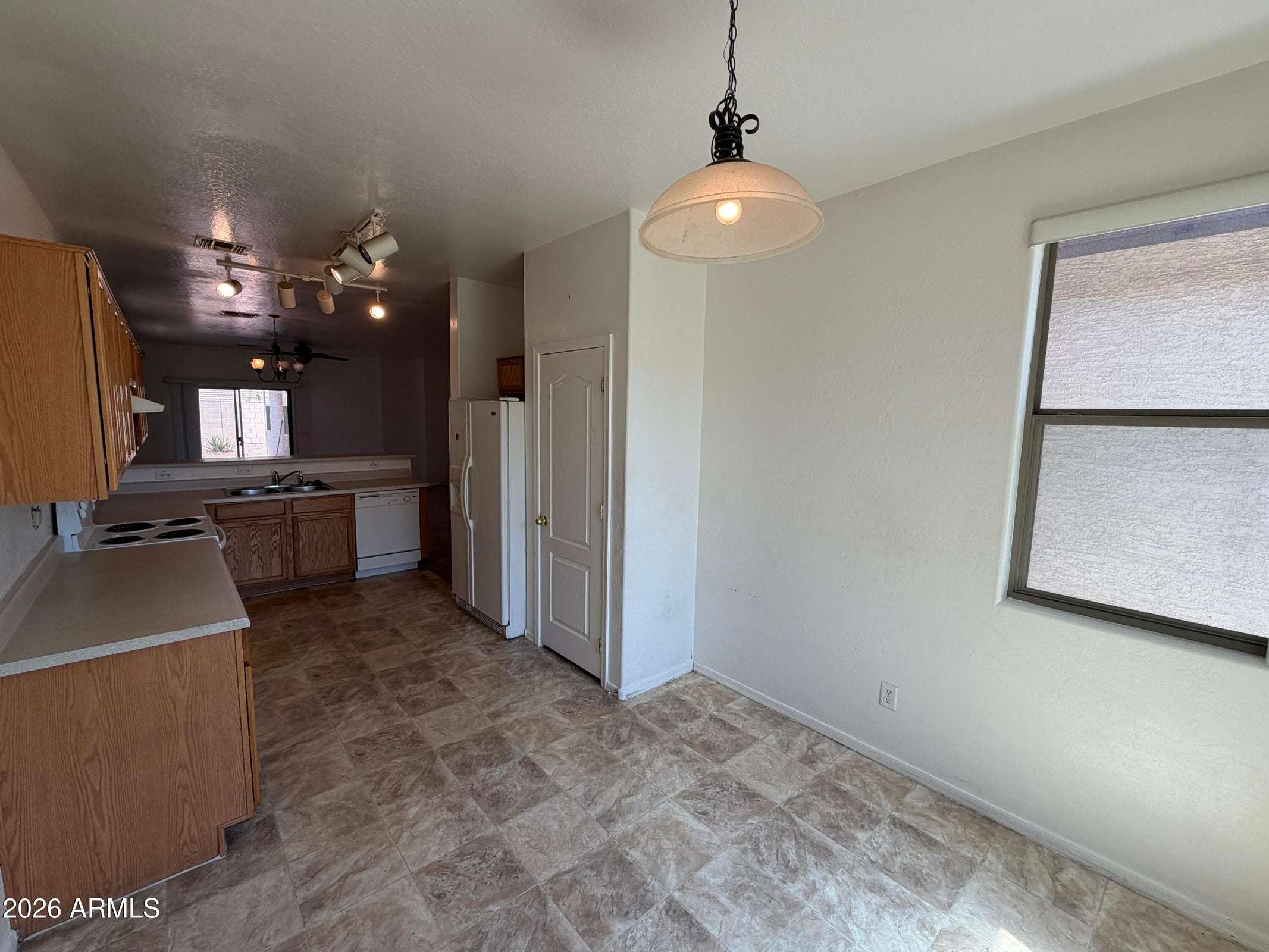 10 of 31. Spacious kitchen with breakfast bar, extensive cabinetry, ample prep space, and a layout that flows effortlessly into the main living area, making daily living both comfortable and convenient.