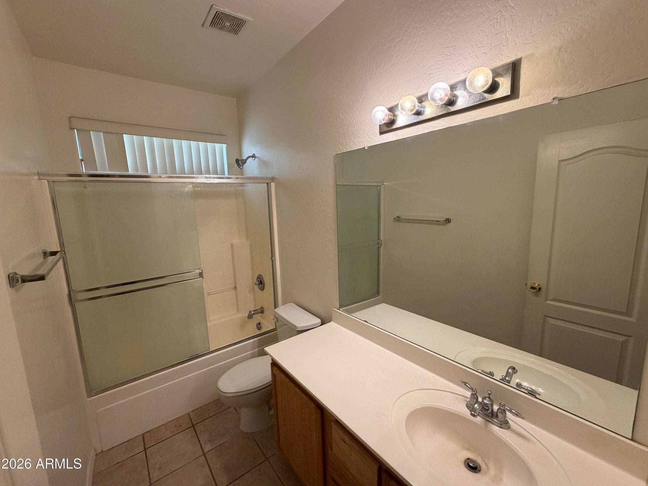 20 of 31. Spacious full bathroom featuring dual sinks, a tub and shower combination, generous countertop space, and a bright, functional layout ideal for daily routines.