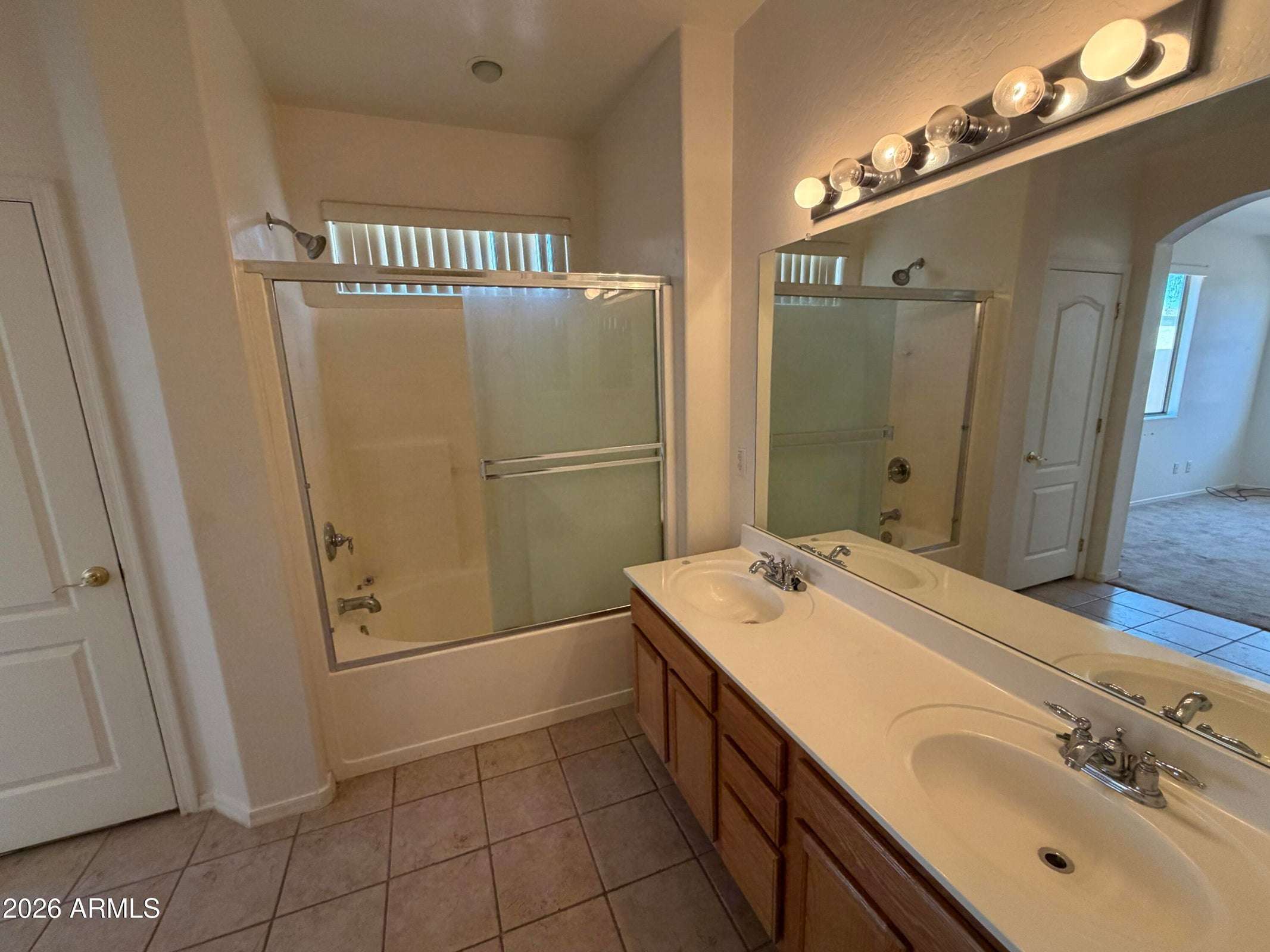 24 of 31. Bright full bathroom offering dual sinks, a tub and shower combination, and plenty of counter space for convenient daily routines.