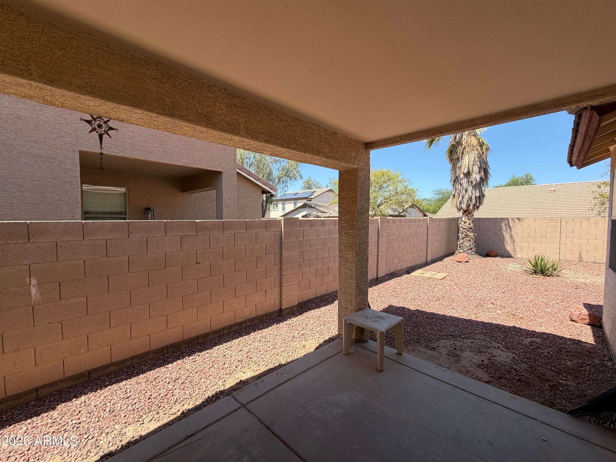 29 of 31. Enjoy outdoor living under the covered patio overlooking a private backyard with easy-care desert landscaping, perfect for entertaining or unwinding.