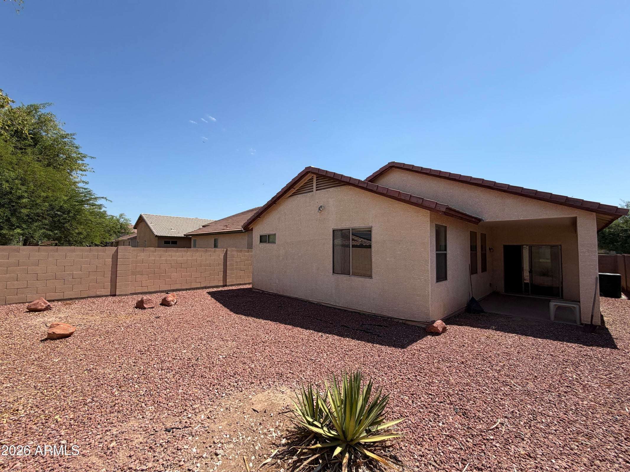 30 of 31. Private fenced backyard with attractive desert landscaping and ample outdoor space, providing a peaceful setting that's easy to maintain in this Phoenix rental.