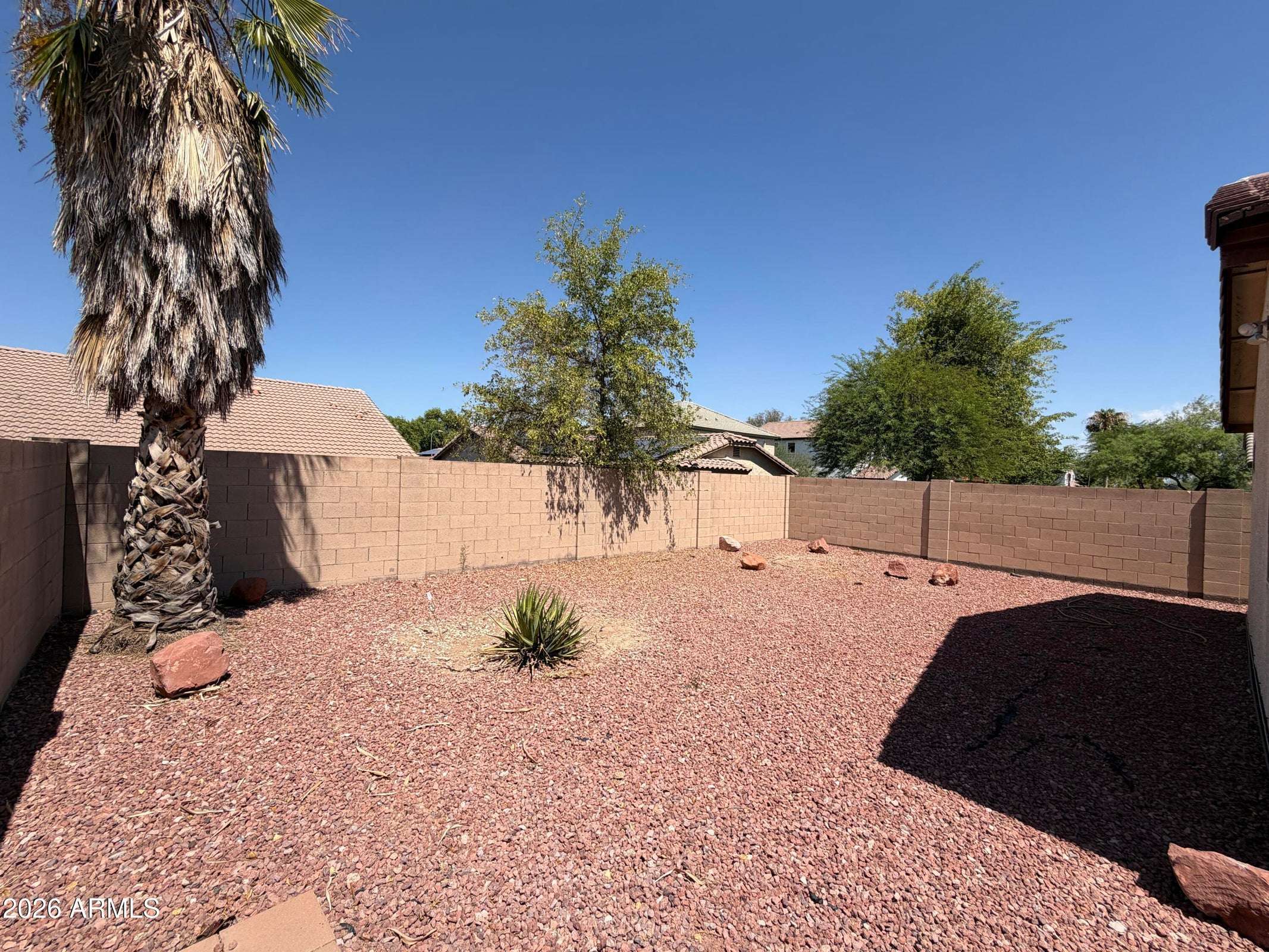 31 of 31. Large backyard featuring easy-care desert landscaping, mature trees, and a fully fenced layout that offers privacy and room to relax or entertain. A great outdoor feature of this Phoenix rental property.