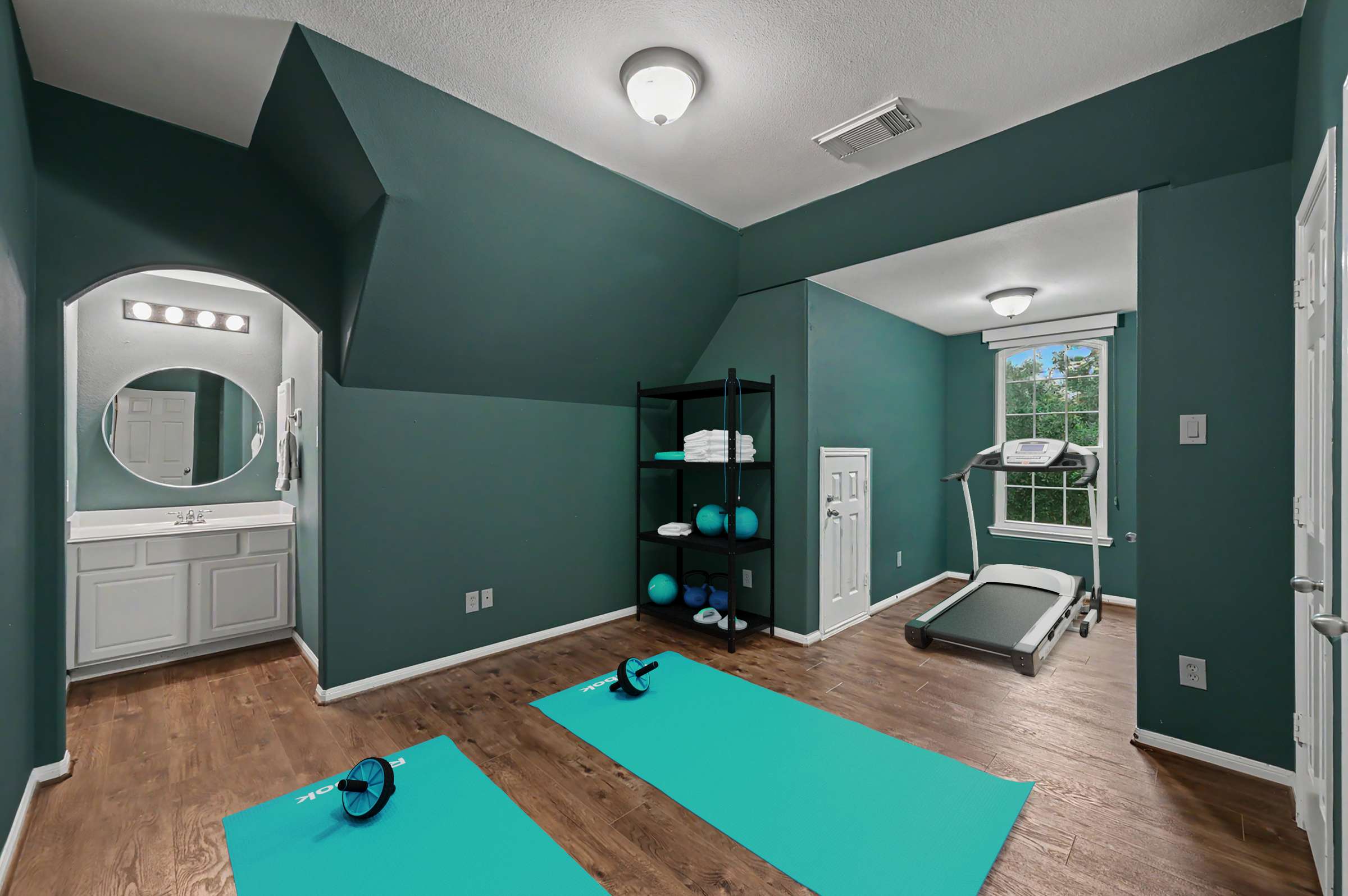 46 of 71. Spacious multi-functional room featuring a home gym setup, ideal for fitness enthusiasts and wellness activities.