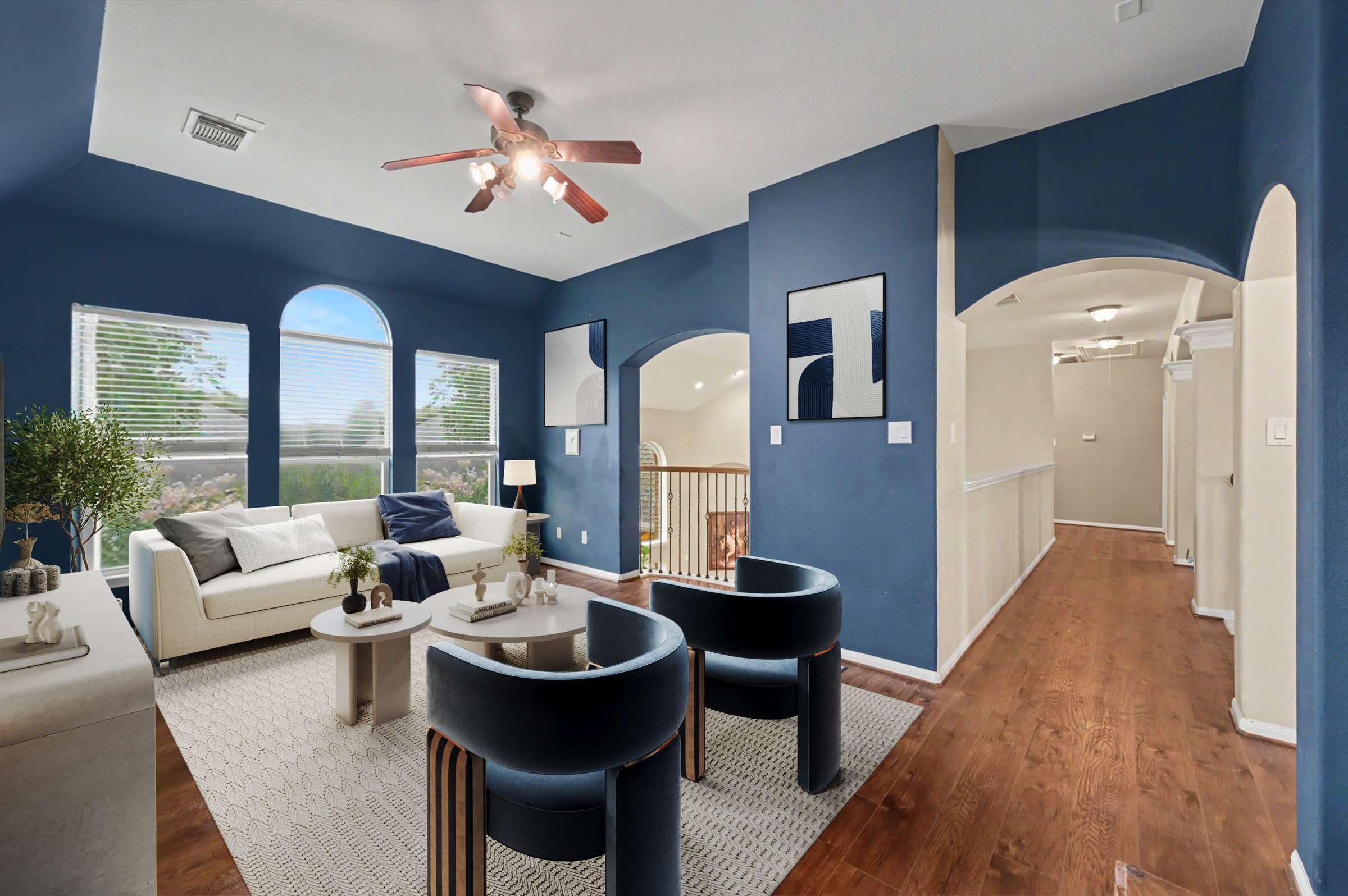 9 of 71. Modern living space featuring unique blue walls, ample natural light, and an inviting open layout.