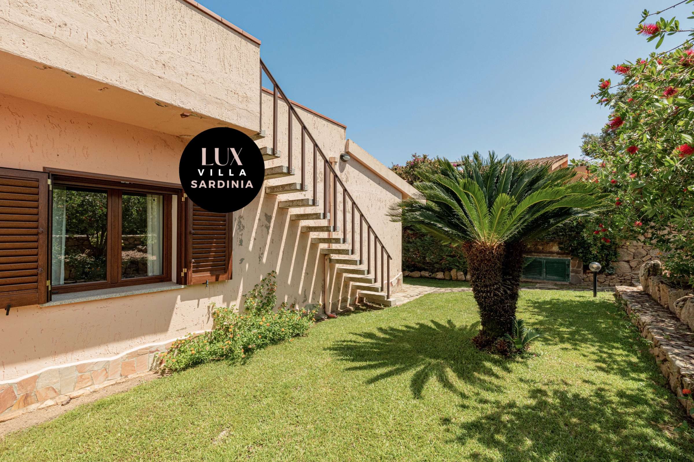 50 of 66. Discover a spacious villa featuring a lovely garden and inviting staircase, perfect for outdoor living.