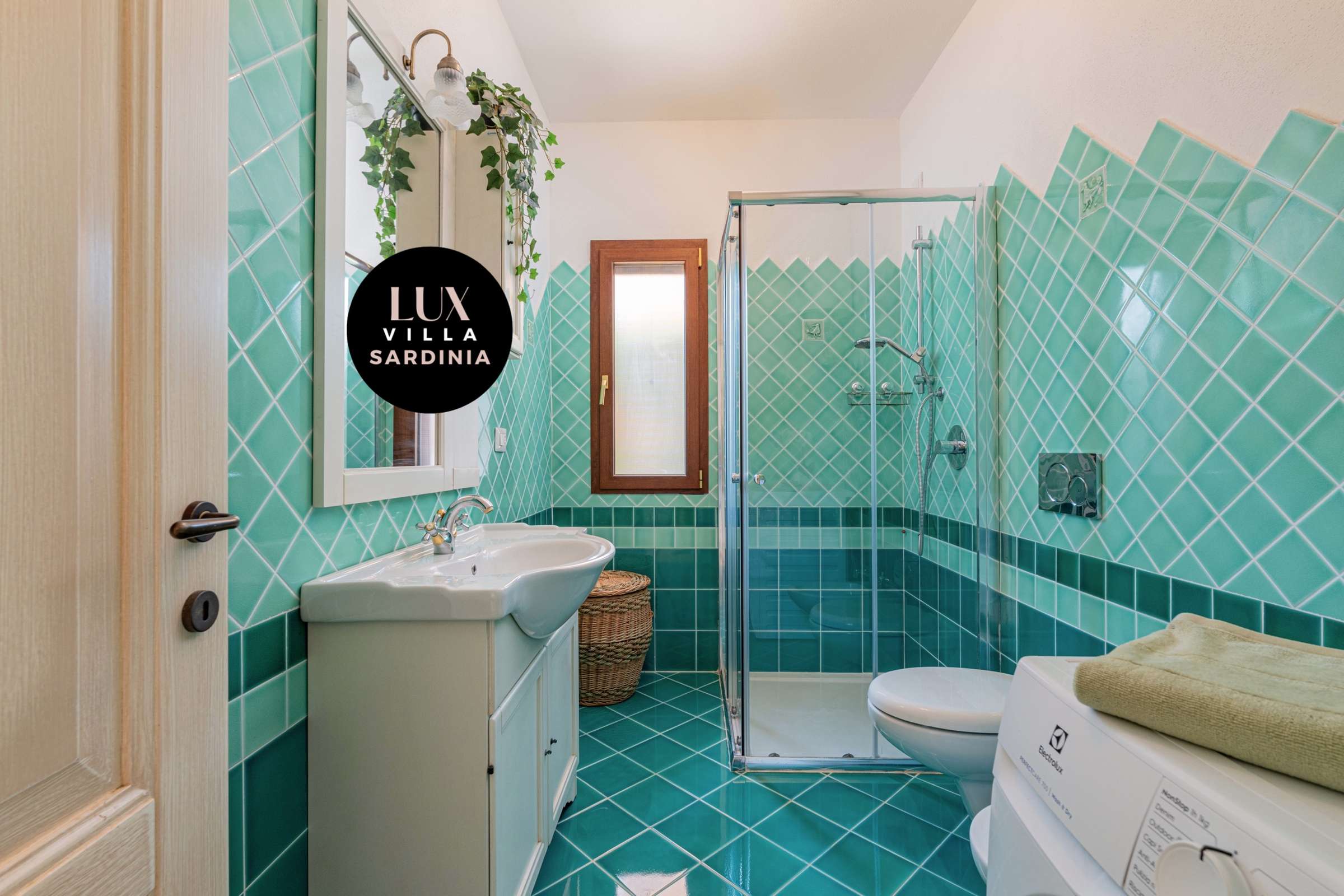 28 of 66. Bright bathroom featuring bold turquoise tiles, modern fixtures, and thoughtful storage options throughout.
