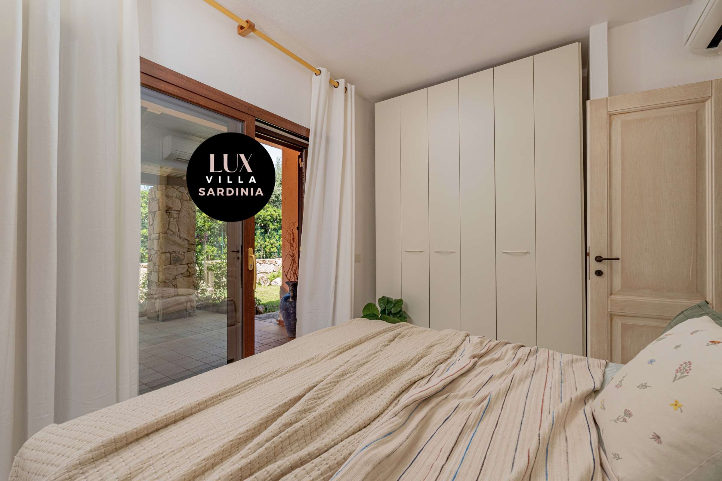 45 of 66. Cozy bedroom featuring ample storage and direct access to a lush outdoor patio area.