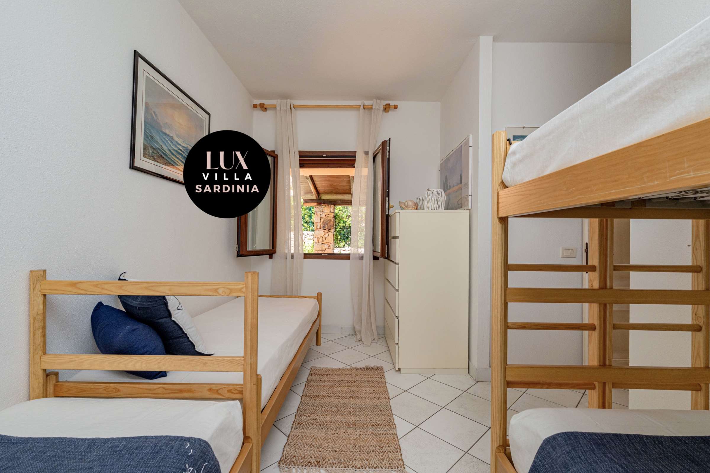 48 of 66. Bright and airy room featuring bunk beds, natural light, and views of the surrounding greenery.