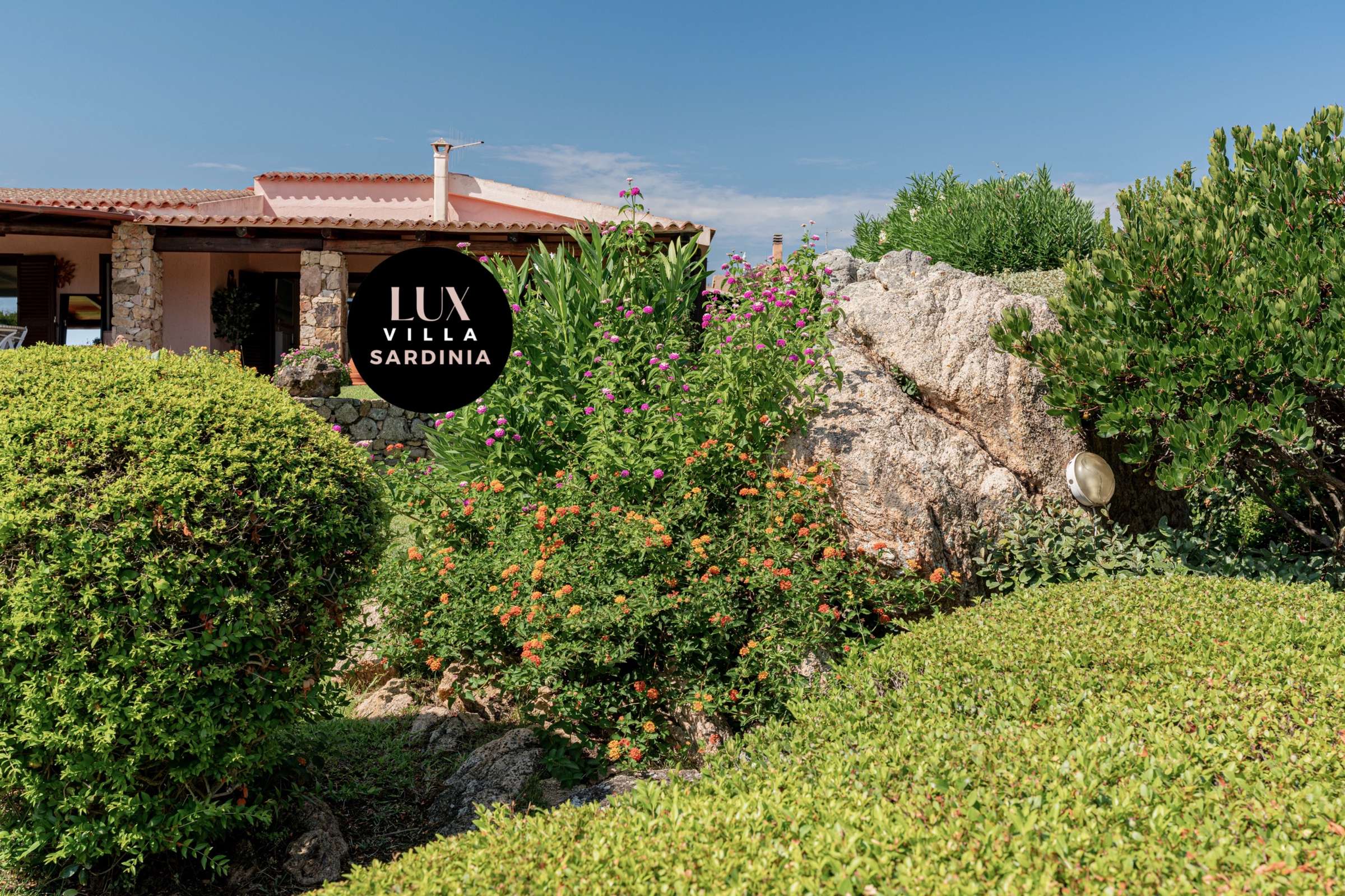 51 of 66. Discover a unique villa in Sardinia, surrounded by vibrant gardens and stunning natural rock formations.