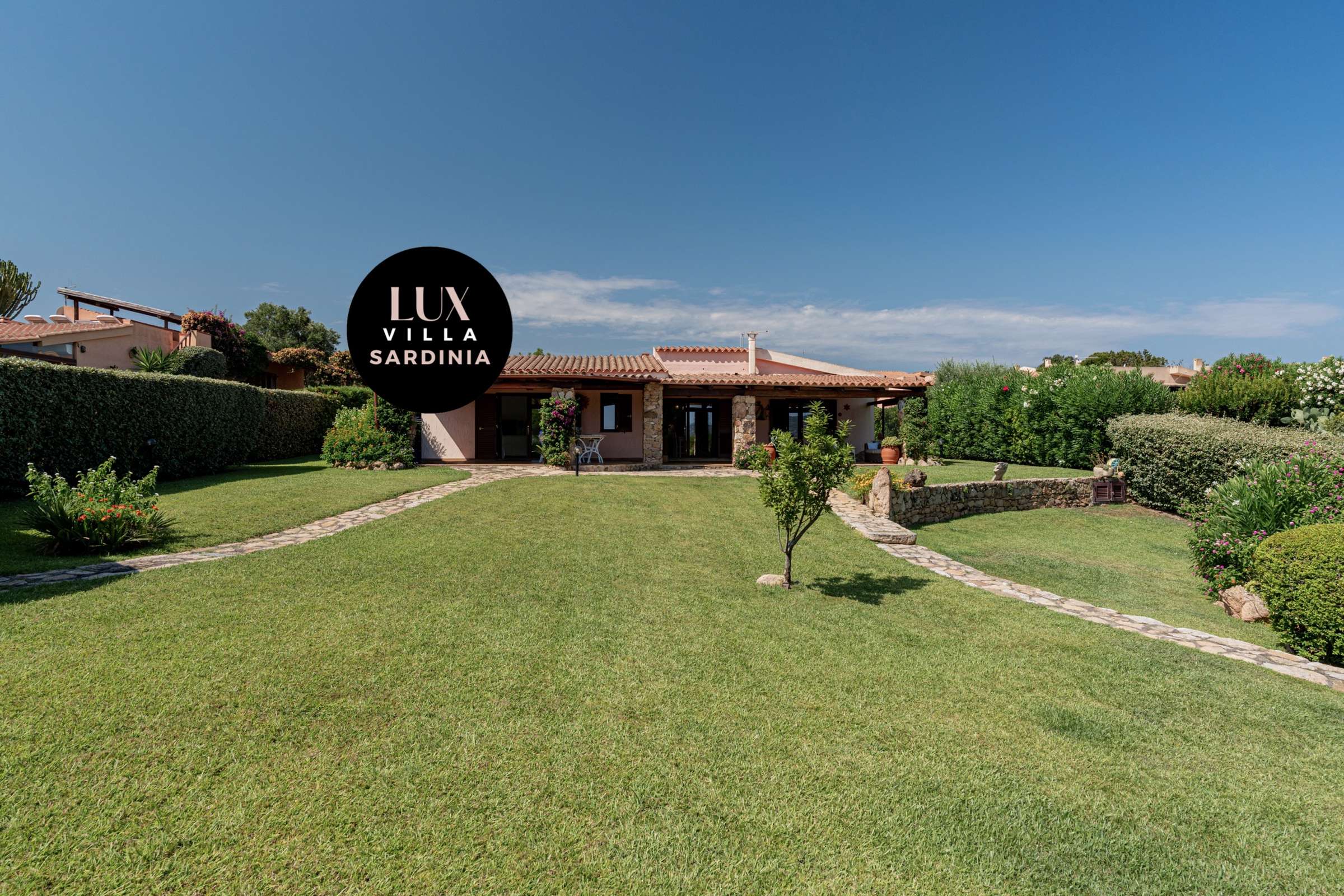 7 of 66. Spacious villa in Sardinia, surrounded by lush gardens and scenic views, perfect for relaxation and gatherings.