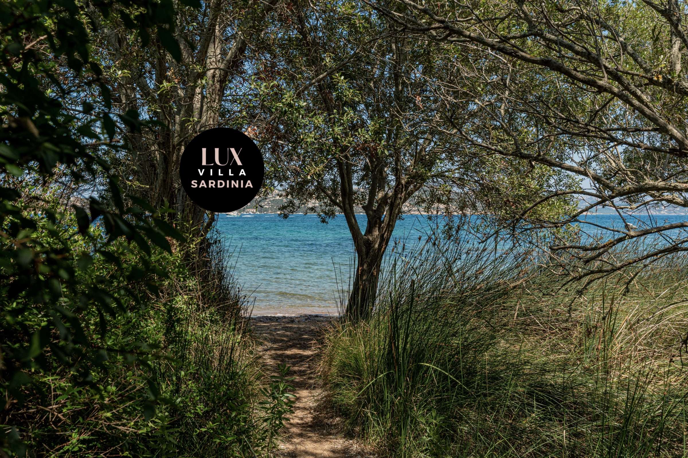 54 of 66. Discover a tranquil pathway leading to stunning waterfront views in this exclusive Sardinia villa setting.