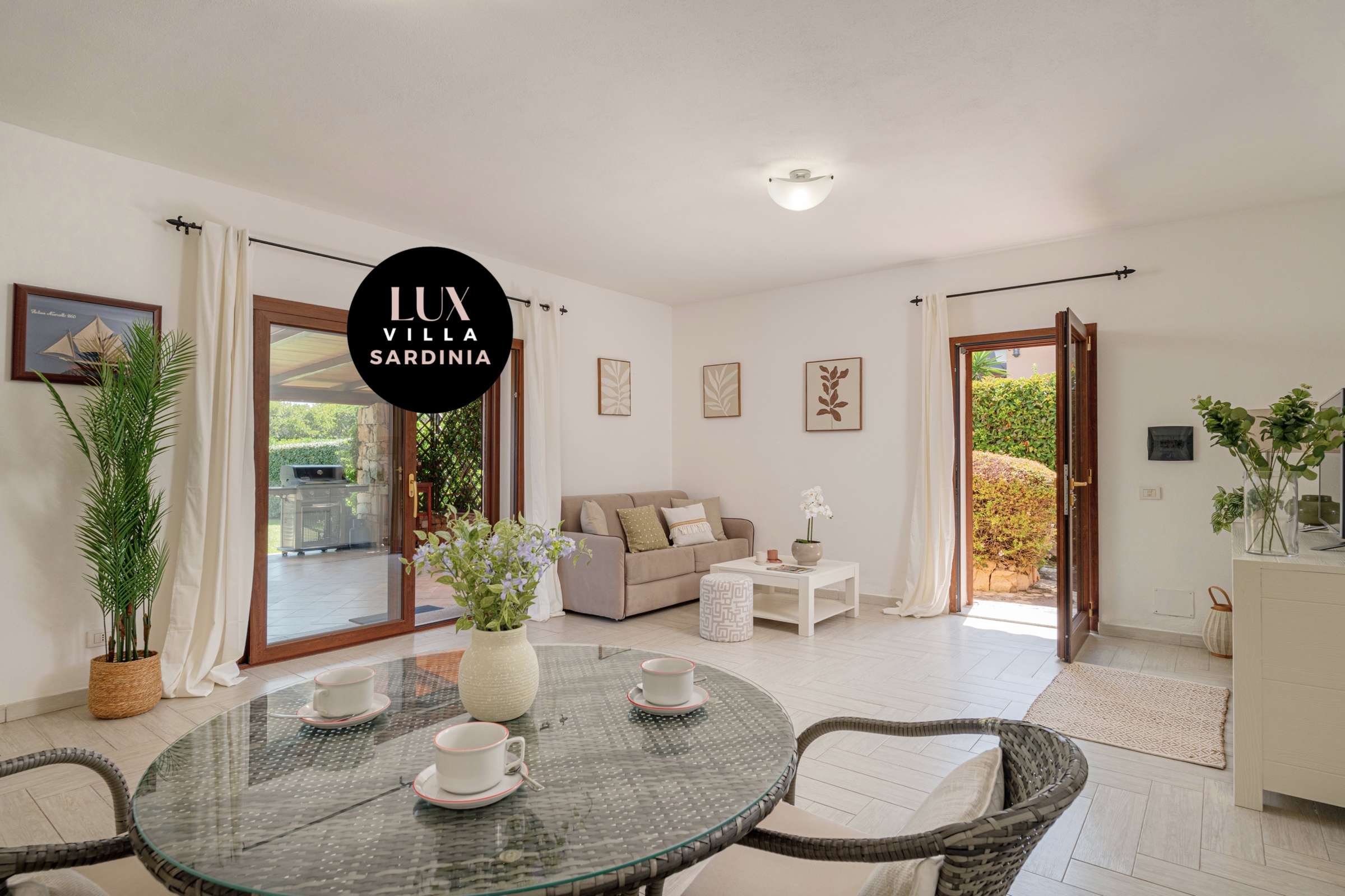 21 of 66. Bright and inviting living space featuring large doors that open to a lush outdoor area.