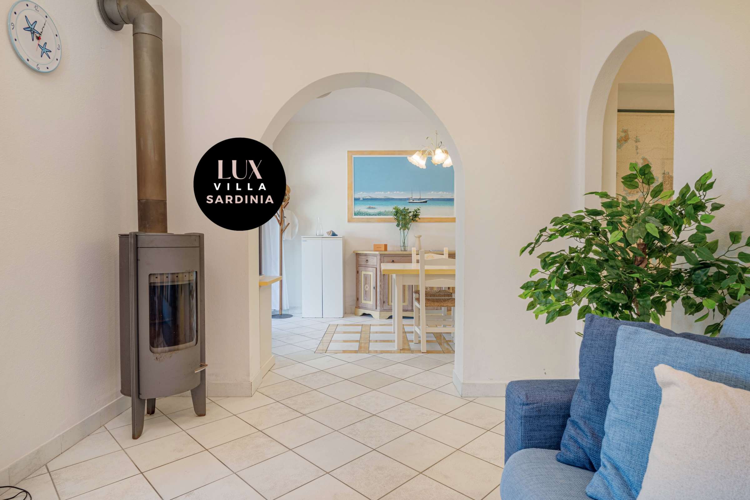 37 of 66. Bright and airy space featuring unique architectural arches and cozy wood stove for year-round comfort.