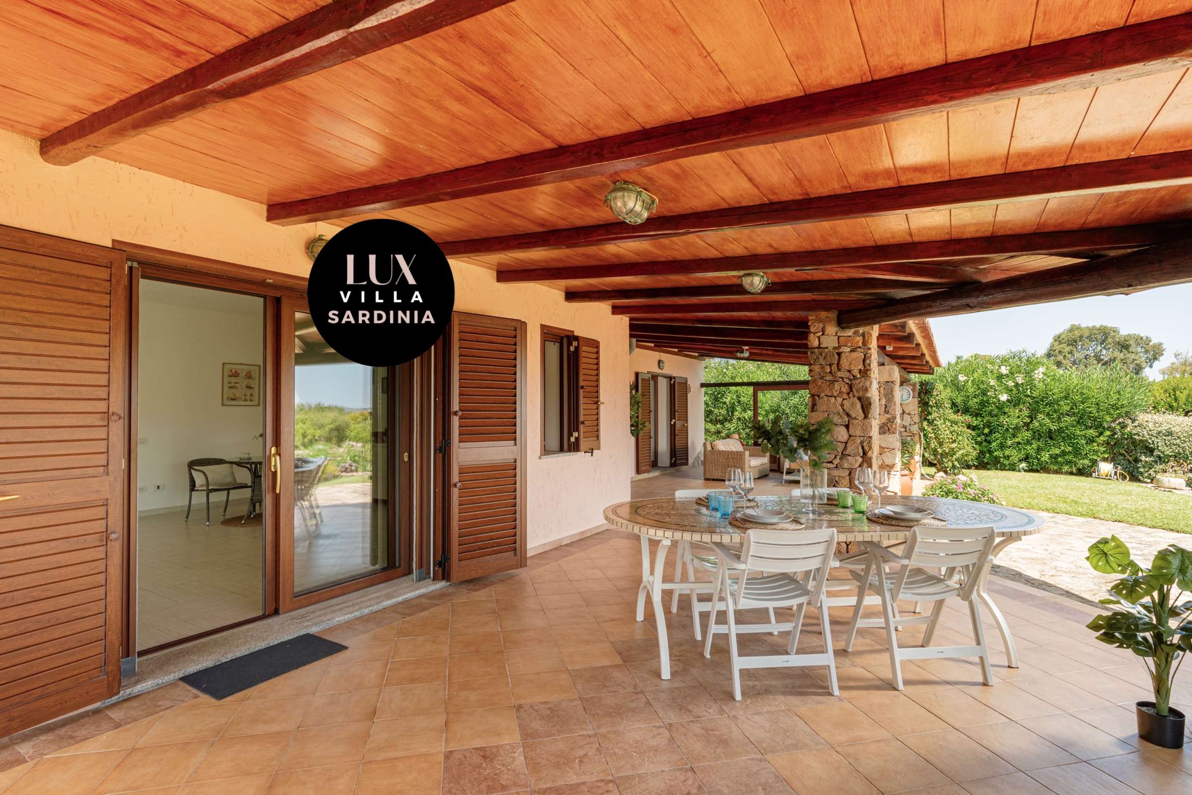 18 of 66. Spacious outdoor patio perfect for entertaining, surrounded by lush greenery and scenic views of Sardinia.