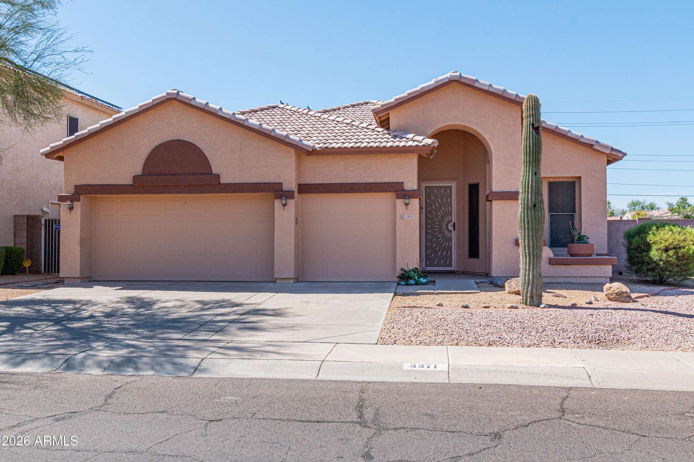 1 of 29. Charming Phoenix residence with attractive desert landscaping, tile roof architecture, and a spacious three-car garage. The inviting exterior highlights the home's low-maintenance lifestyle and excellent curb appeal.