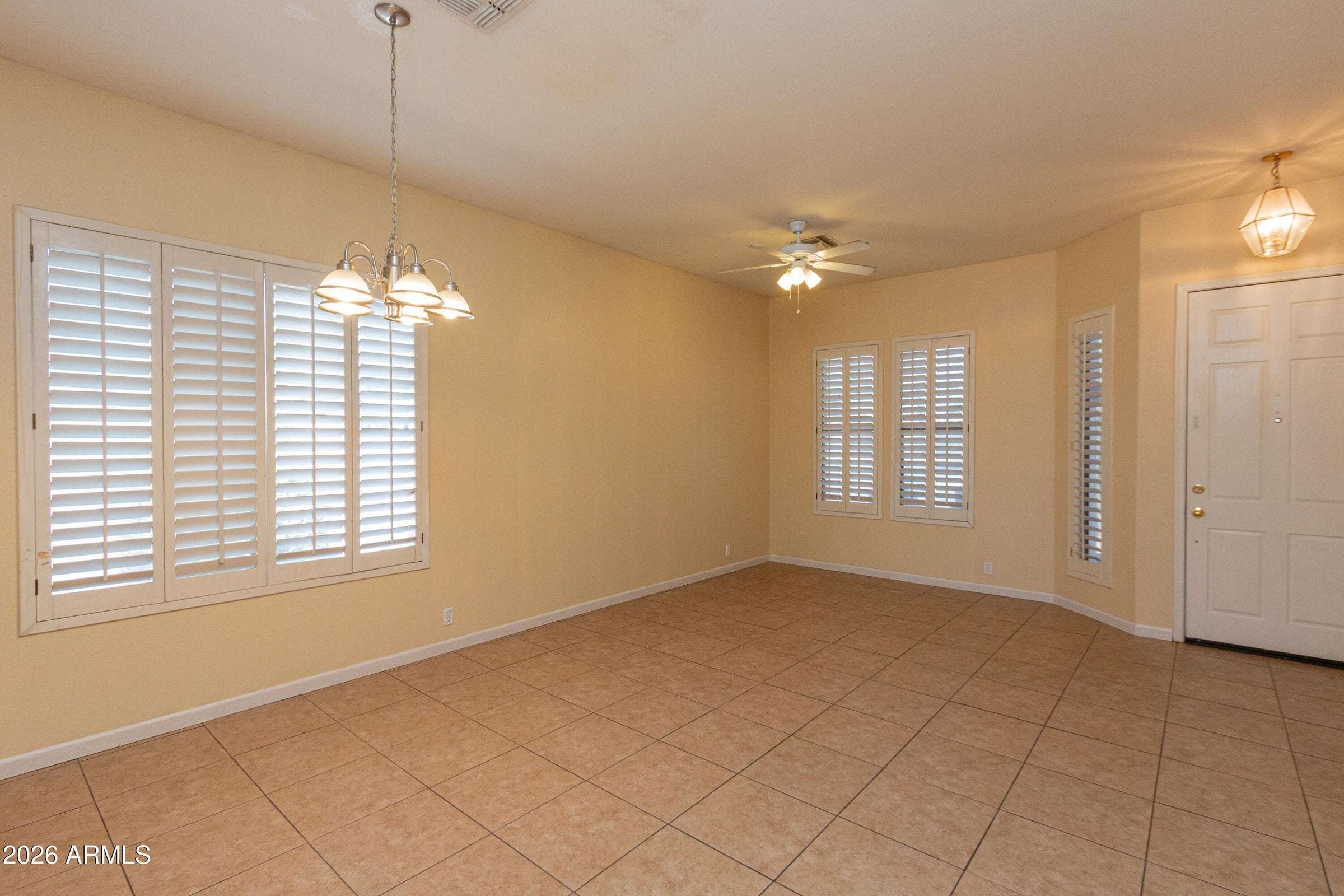 4 of 29. Spacious front living and dining area enhanced by natural light and classic plantation shutters. Tile flooring throughout provides easy maintenance and timeless style.