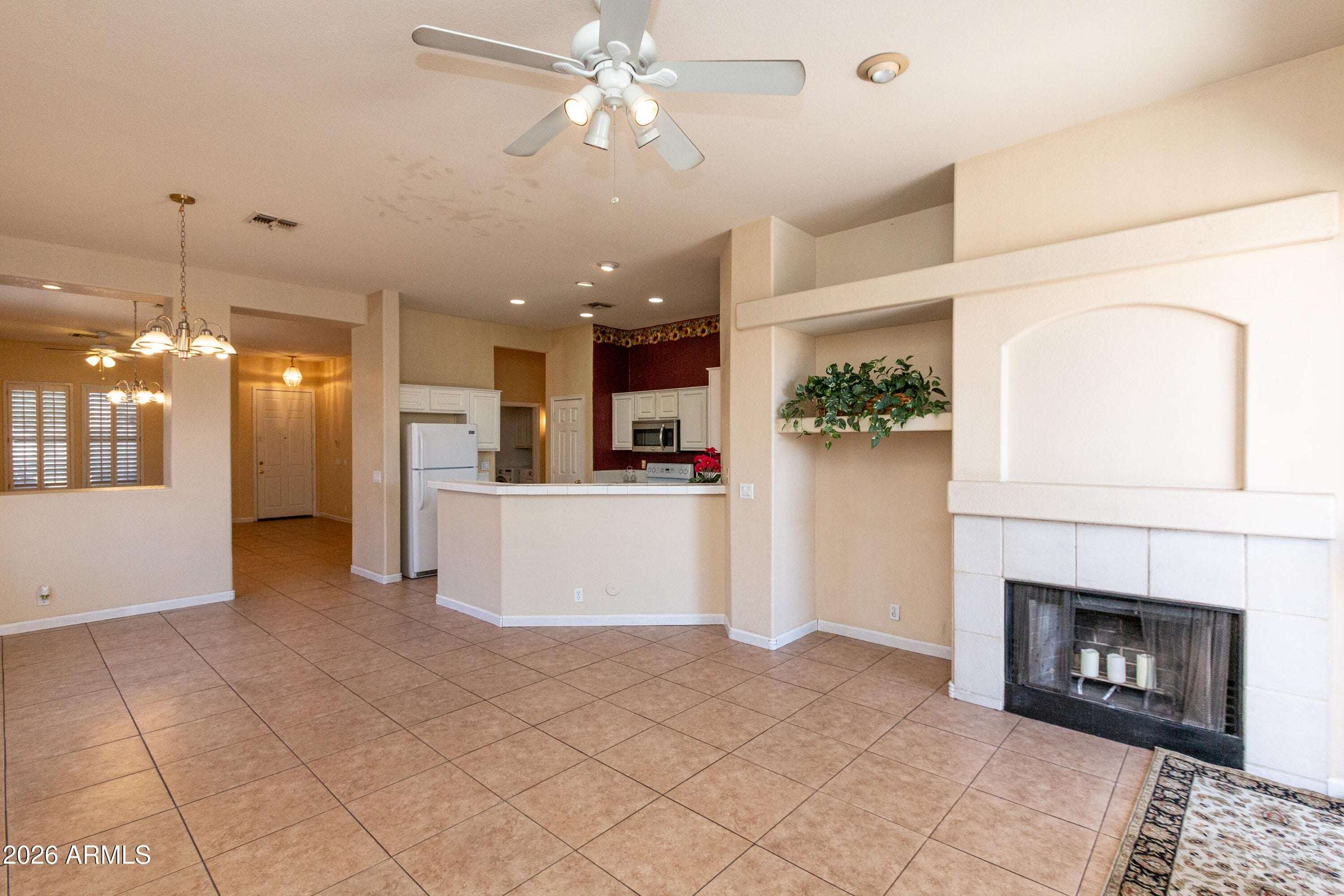8 of 29. Spacious interior showcasing an open floor plan with tile flooring, recessed lighting, and excellent flow between living areas. Designed for both entertaining and everyday convenience.