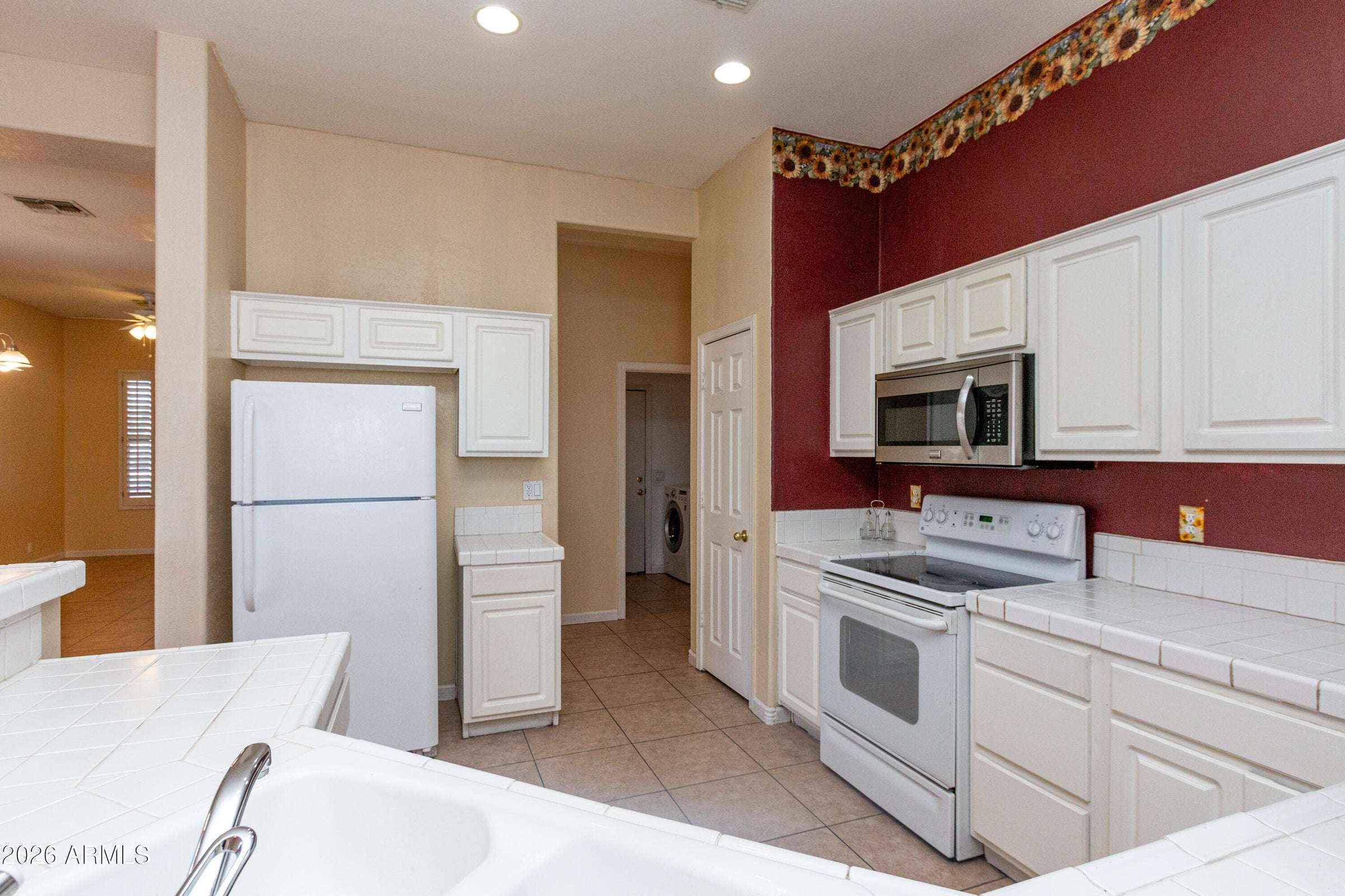 10 of 29. Spacious kitchen featuring extensive cabinet storage, generous counter space, and recessed lighting. A practical layout designed to support daily living while maintaining an open and airy feel.