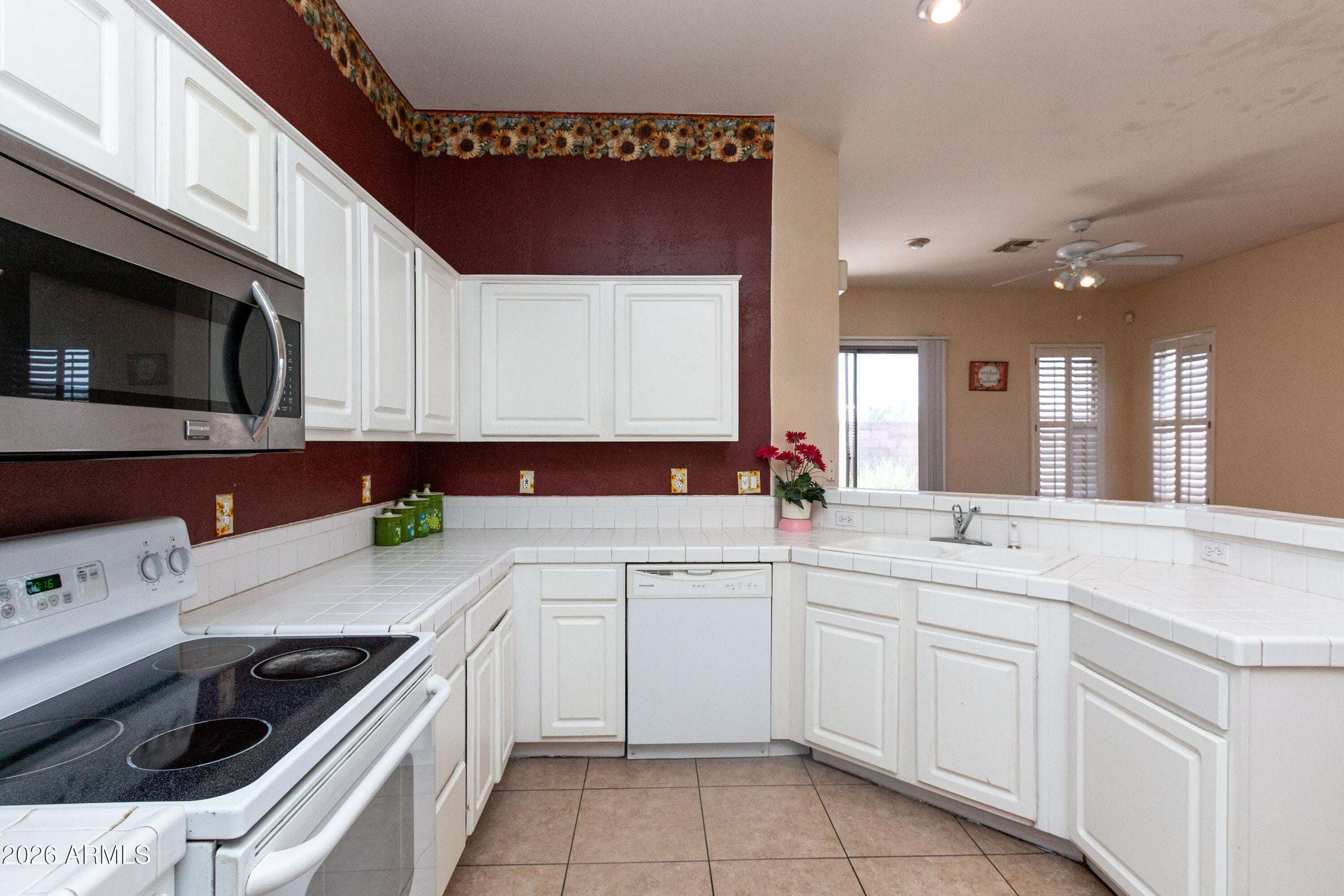 13 of 29. Spacious kitchen with wraparound counters, built-in appliances, and views into the living areas. A functional space that blends convenience with an open-concept floor plan.