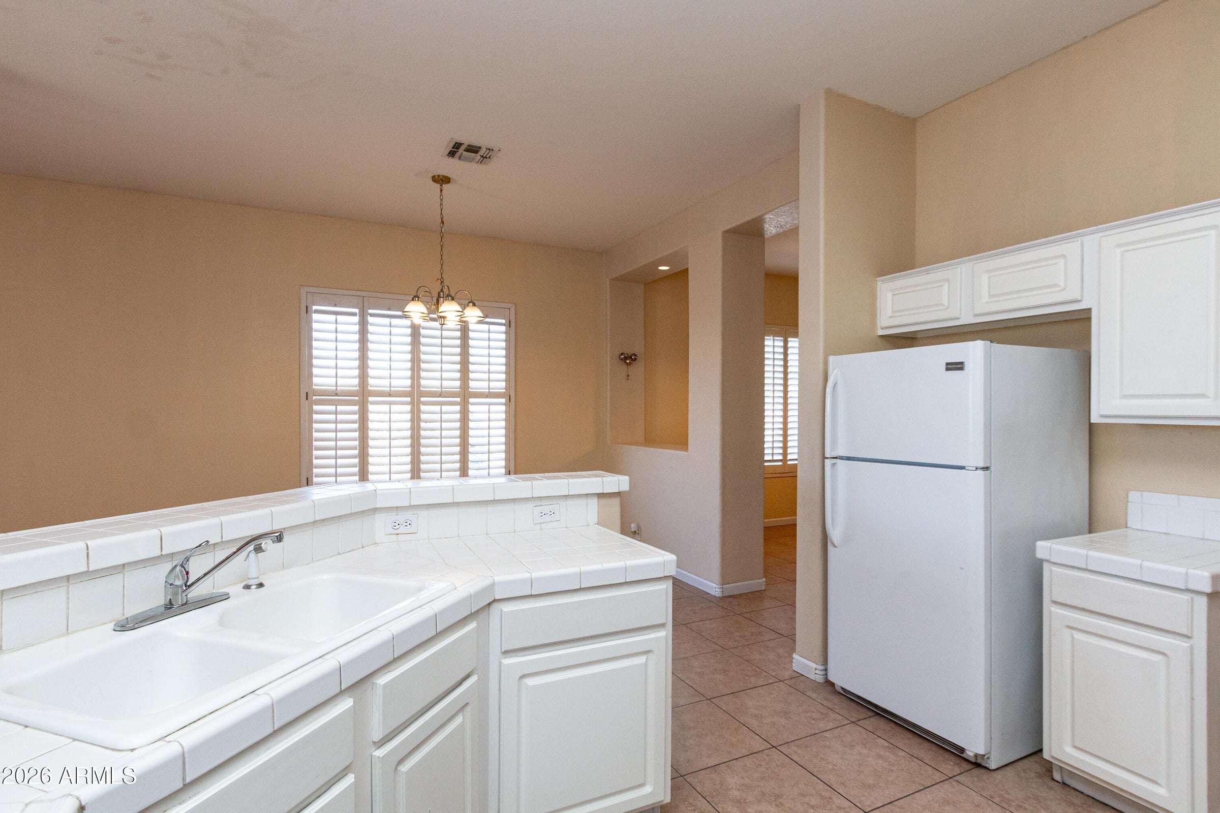 14 of 29. Inviting dining area enhanced by plantation shutters and natural light. Positioned adjacent to the kitchen, it provides a comfortable space for daily meals and gatherings.