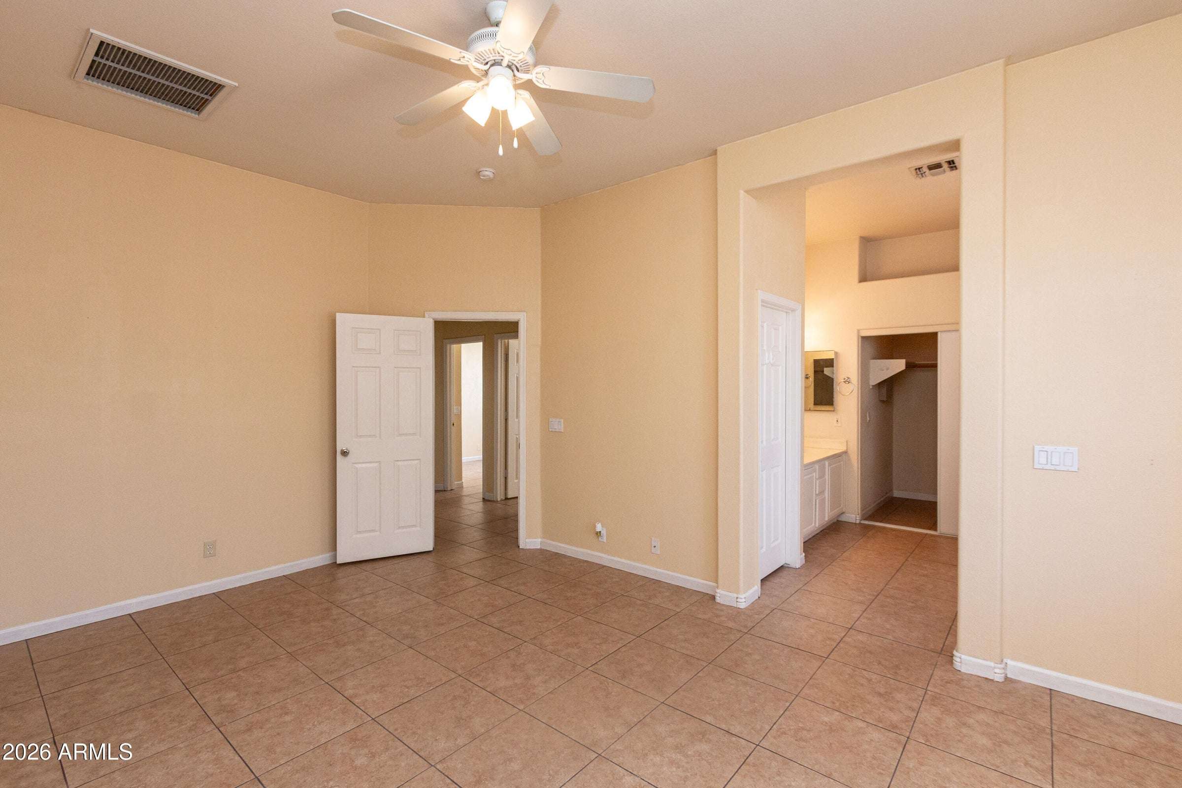 15 of 29. Spacious primary bedroom with high ceilings, tile flooring, and a ceiling fan for year-round comfort. A private retreat designed to accommodate a variety of furniture layouts.