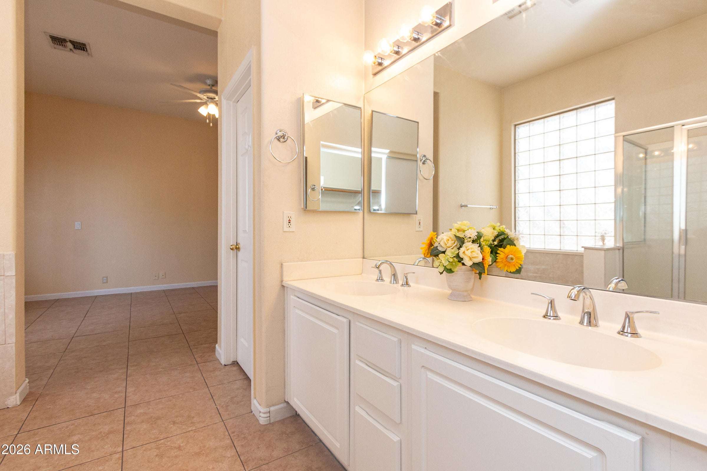 16 of 29. Primary bathroom vanity with dual sinks, expansive mirrors, and generous counter space. An ideal setup for busy mornings and everyday convenience.