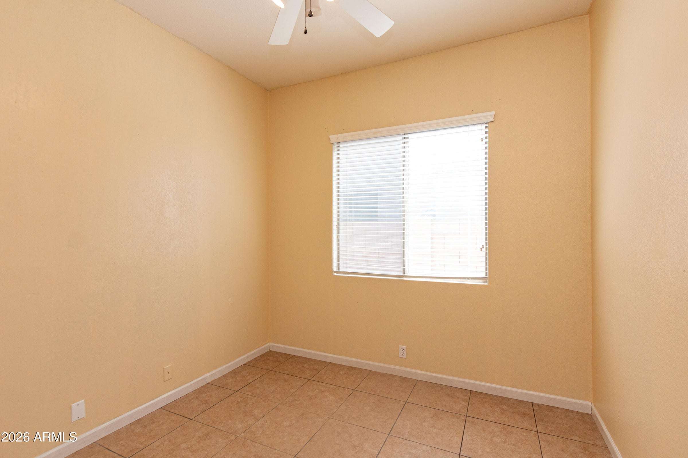 19 of 29. Secondary bedroom offering natural light, tile flooring, and versatile functionality. Perfect for guests, family members, a study, or a dedicated workspace.