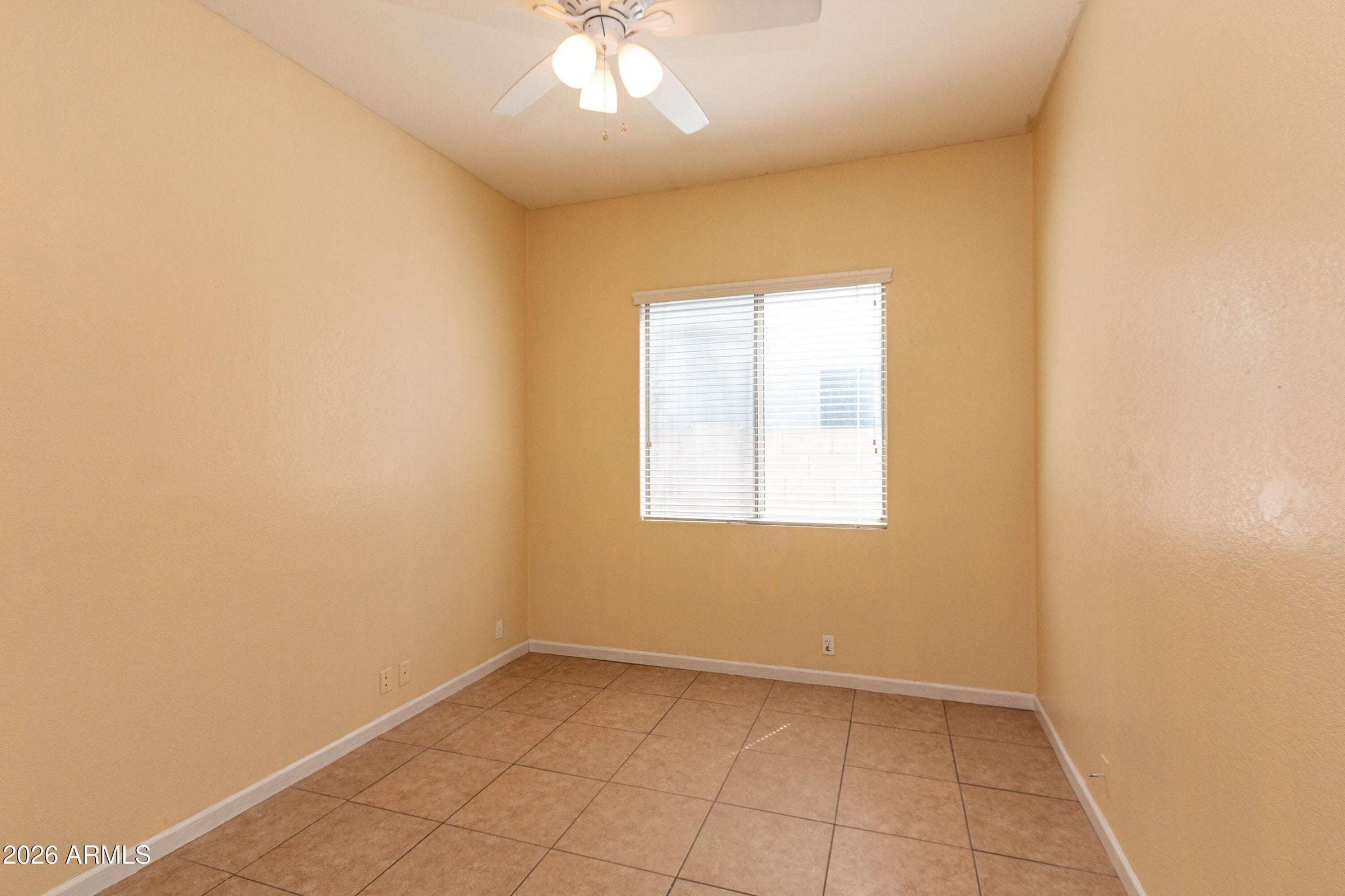 21 of 29. Secondary bedroom with tile flooring, ceiling fan, and natural light. This adaptable room can easily serve as a guest suite, home office, study area, or personal retreat.