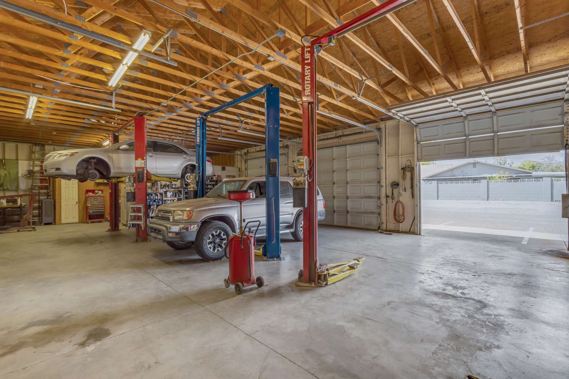 3 of 43. Expansive workshop interior featuring automotive lifts, multiple service bays, high ceilings, and abundant work space. Designed for serious vehicle enthusiasts, restoration projects, or commercial-style storage.