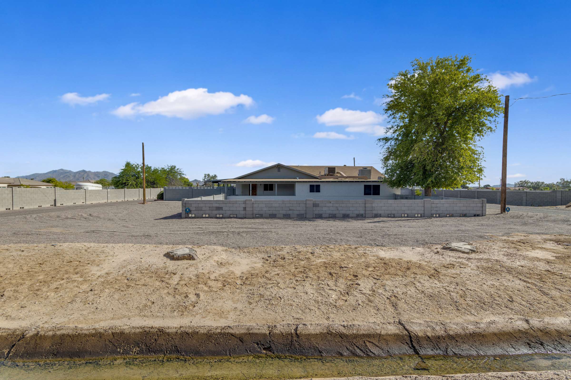 6 of 43. Wide-angle view emphasizes the property's generous acreage, fenced boundaries, and open surroundings, providing outstanding privacy and endless possibilities for outdoor living or future expansion.