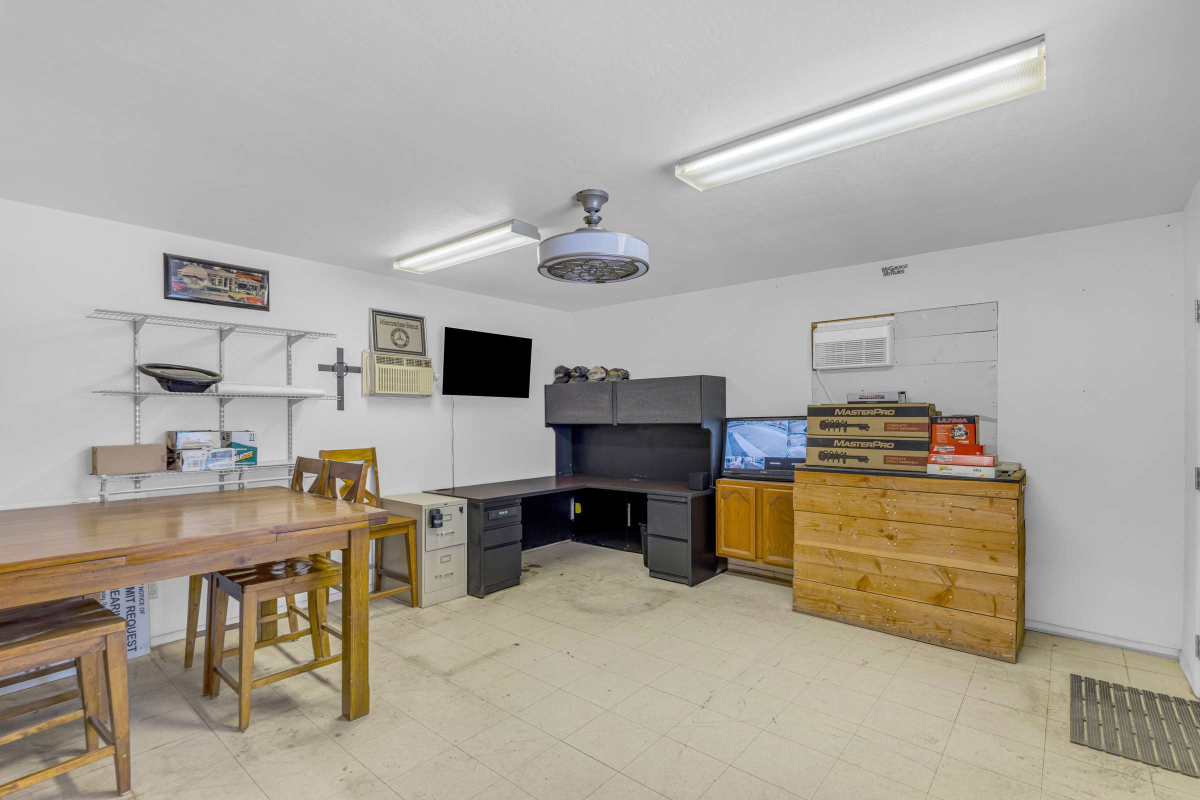 12 of 43. Convenient office space within the detached workshop includes built-in workspace, storage cabinets, and room for managing projects or business operations without leaving the property.